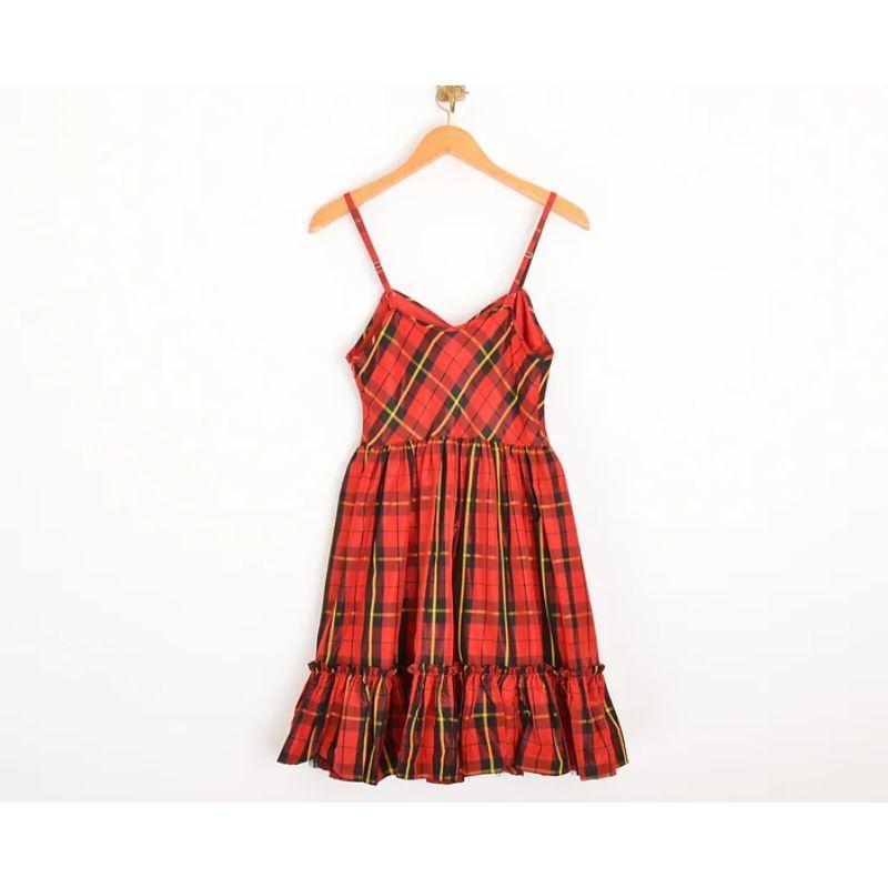 Superb, 1990's Vintage Moschino punky tartan taffetta cocktail dress in a red & yellow colourway, with a fitted waist and mesh layered underskirt. 

MADE IN ITALY !

Features:
Fitted waist
Adjustable shoulder straps
Mesh underskirt
Ra-Ra hem

100%