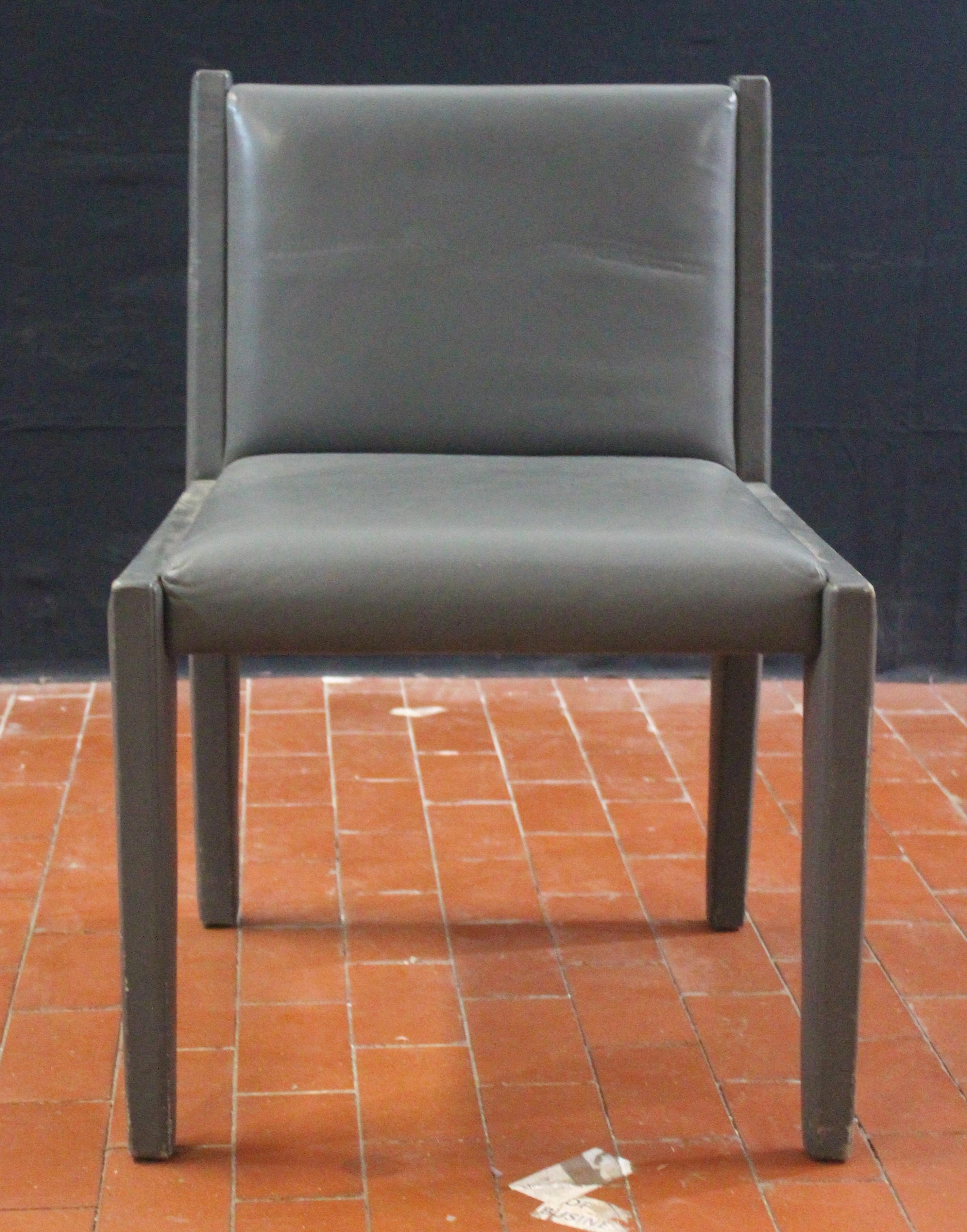 Chic and stylish leather clad side chair in light gray.