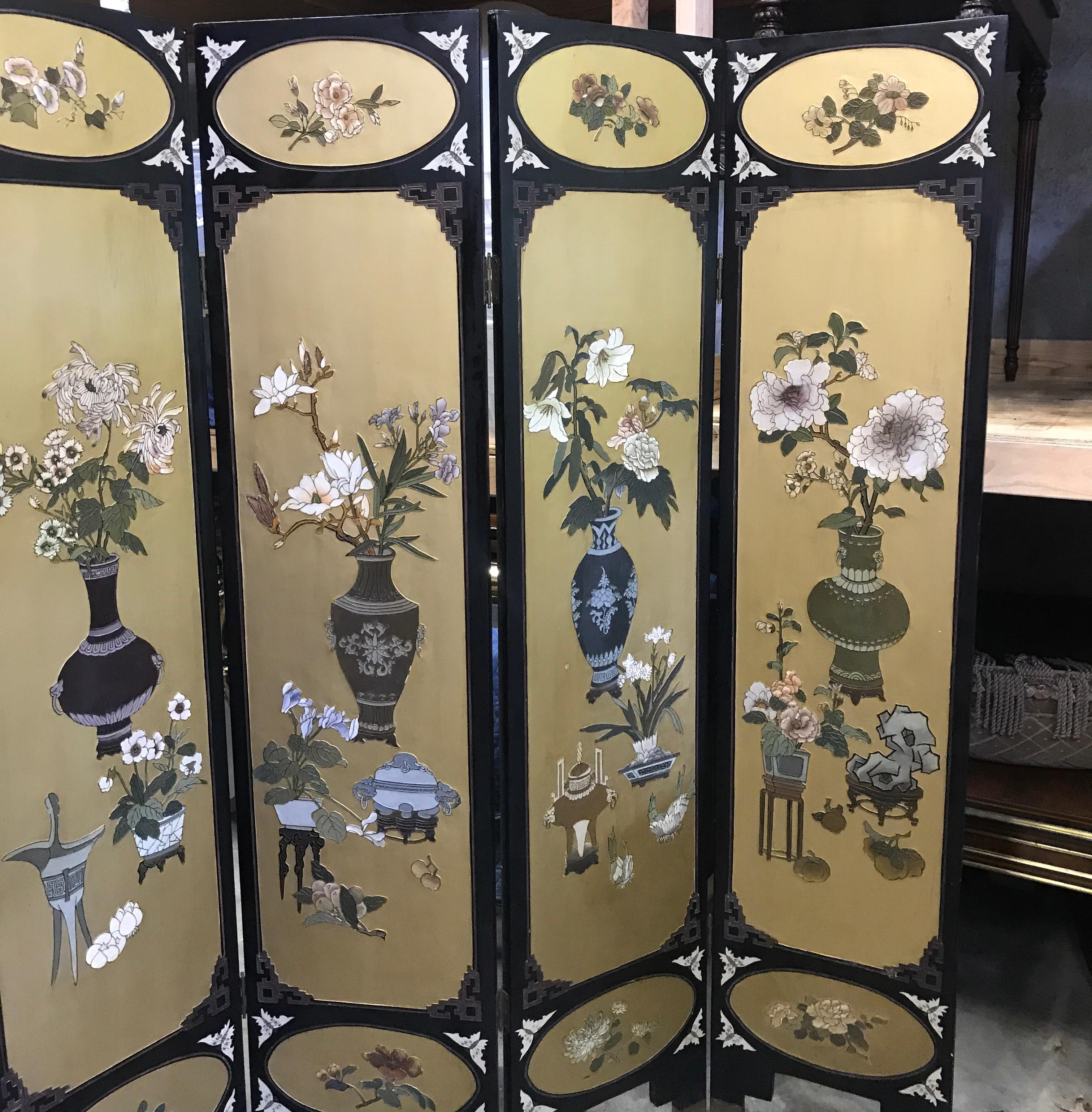The Coromandel screen in black with large gilt cartouches with images of Chinese porcelain vases with floral decoration. The back in black lacquer with engraved decoration. This is a unique and beautiful screen with a lot of gold background, 

The