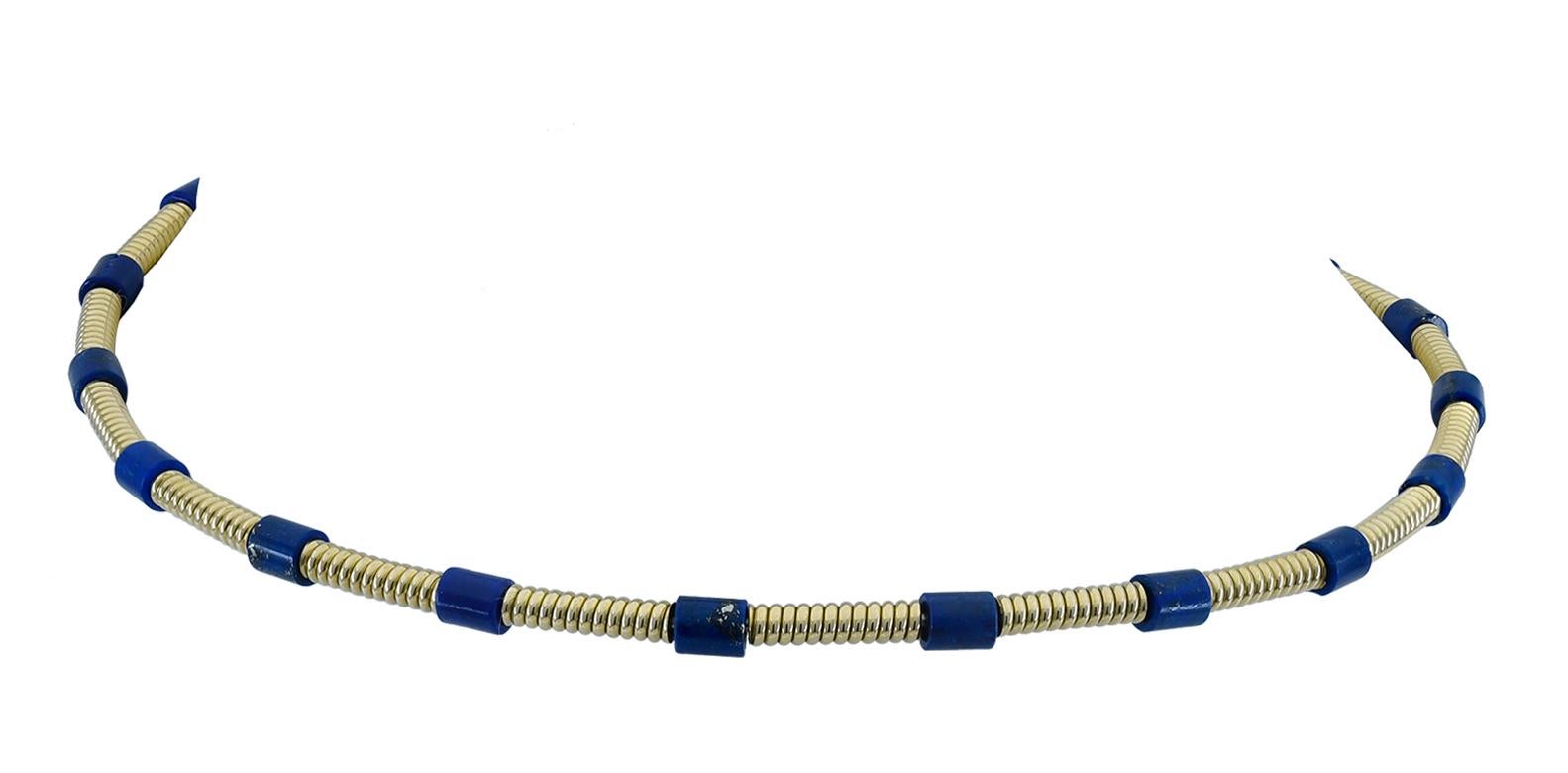 Very smart flexible choker.  Made and signed by CARTIER.  18K yellow gold, set with lapis stations.  User friendly, easy and comfortable to wear.  An ultra-chic accent.  

Alice Kwartler has sold the finest antique gold and diamond jewelry and