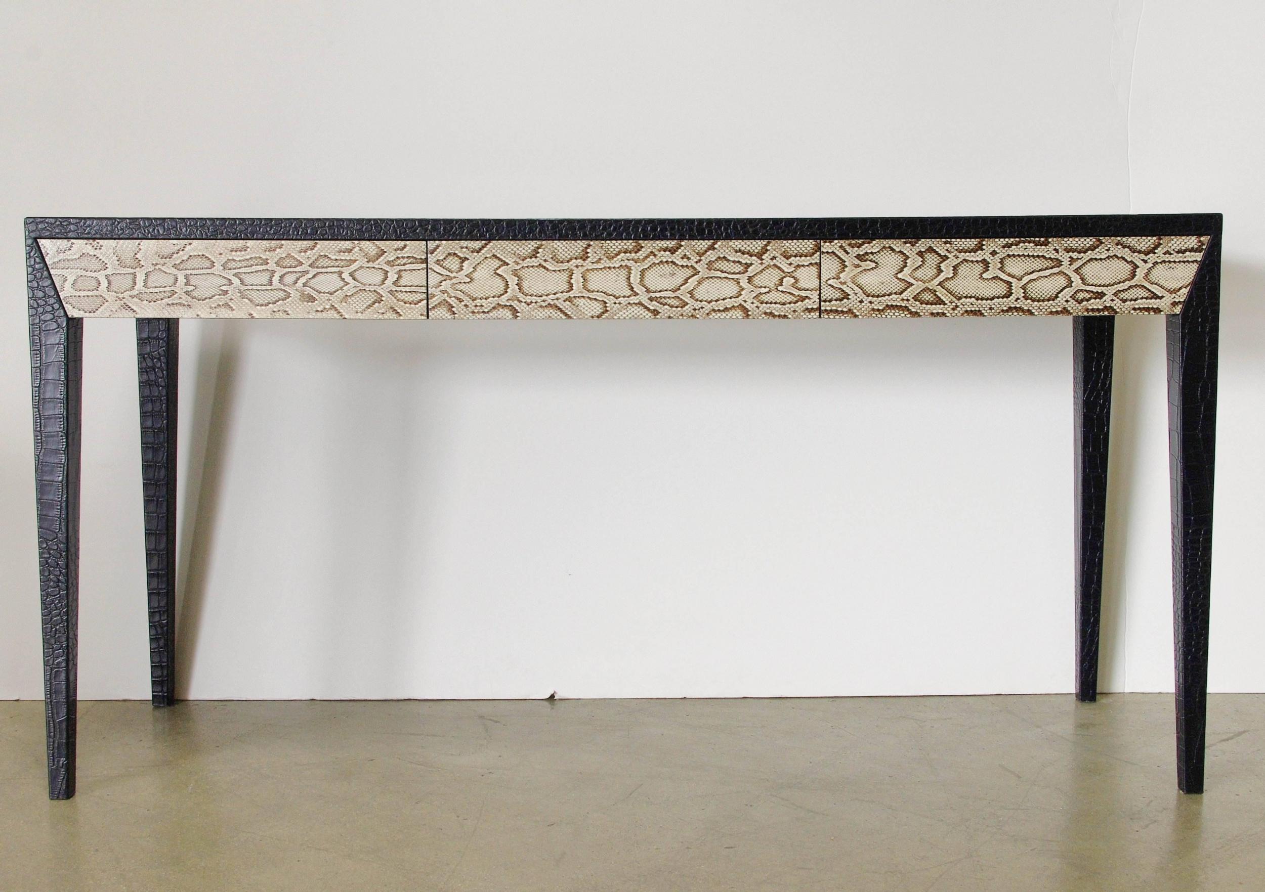 Chic console table with black leather top and legs, and snake skin covering three drawers / Made in U.S.A., 1970s.