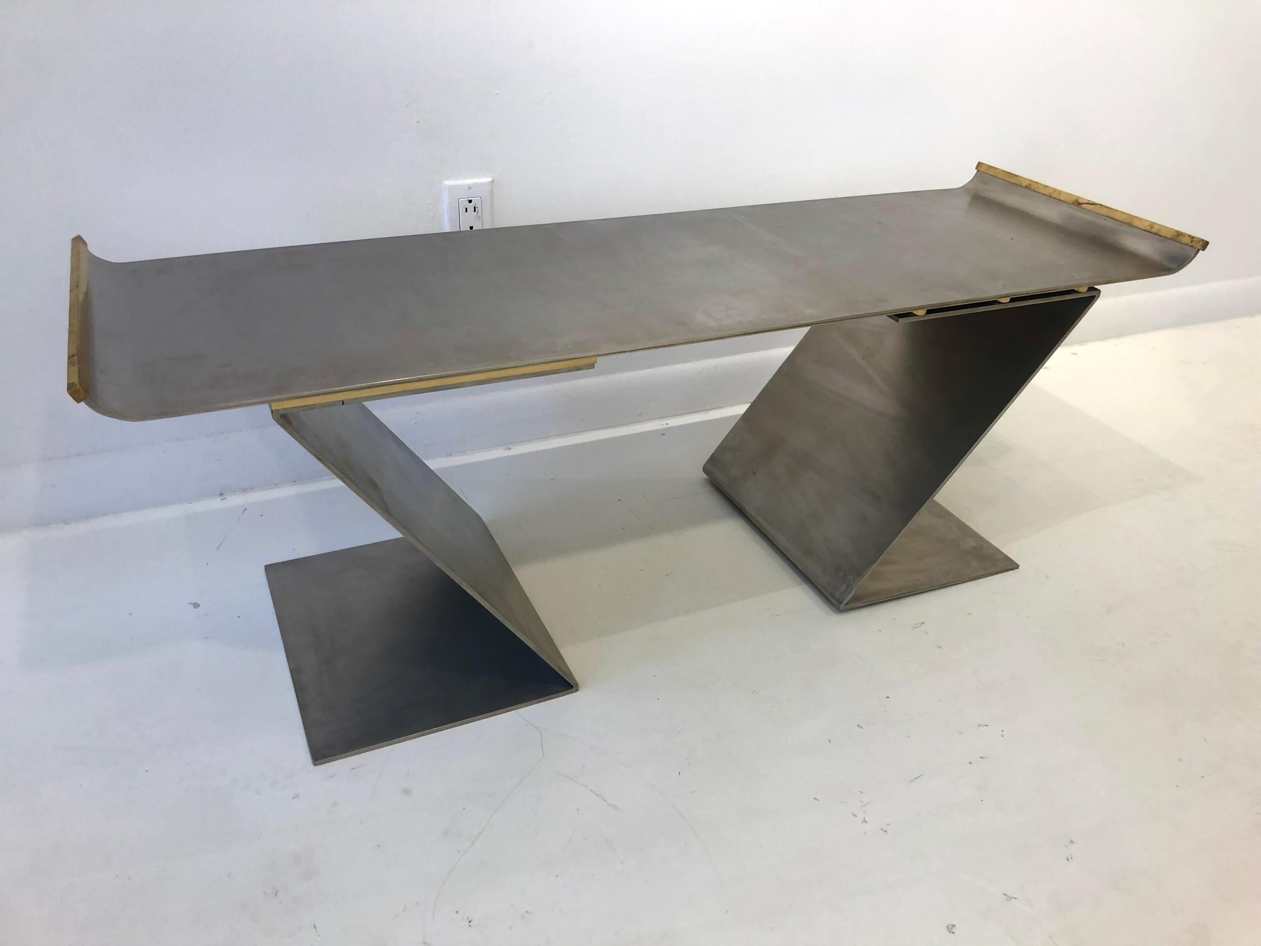 Beautiful and elegant minimalist design. Heavy gauge steel with bronze details is masterfully bent into sculptural form. Labeled and dated 1992 with the name Waal Fathi, possibly the name of the client or architect. Very heavy and impeccable