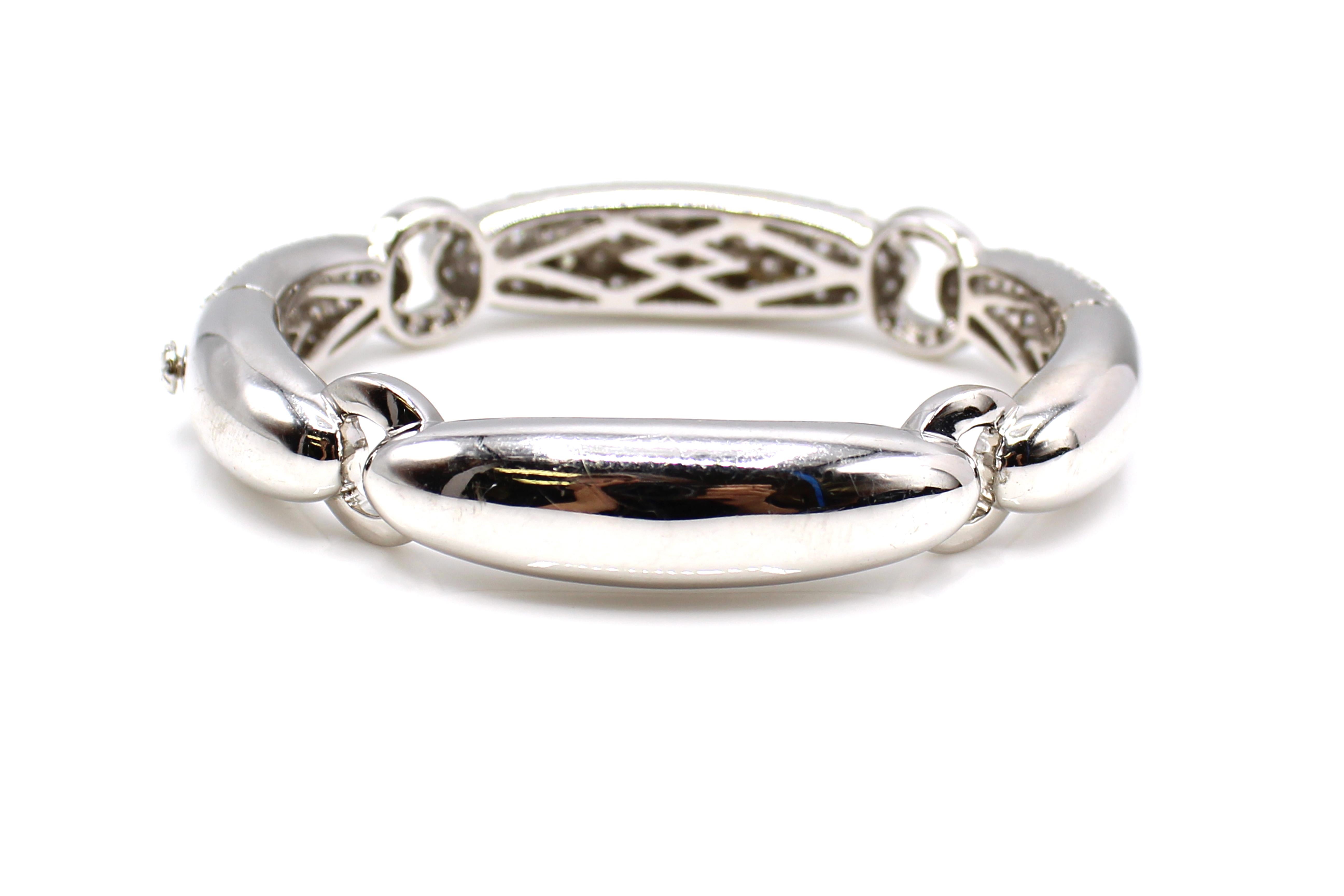 This amazingly well hand-crafted bangle bracelet is a true statement piece. A bold and chic design featuring 3 curved panels all meticulously pave set with perfectly matched bright white and sparkly round brilliant cut diamonds, each connected by