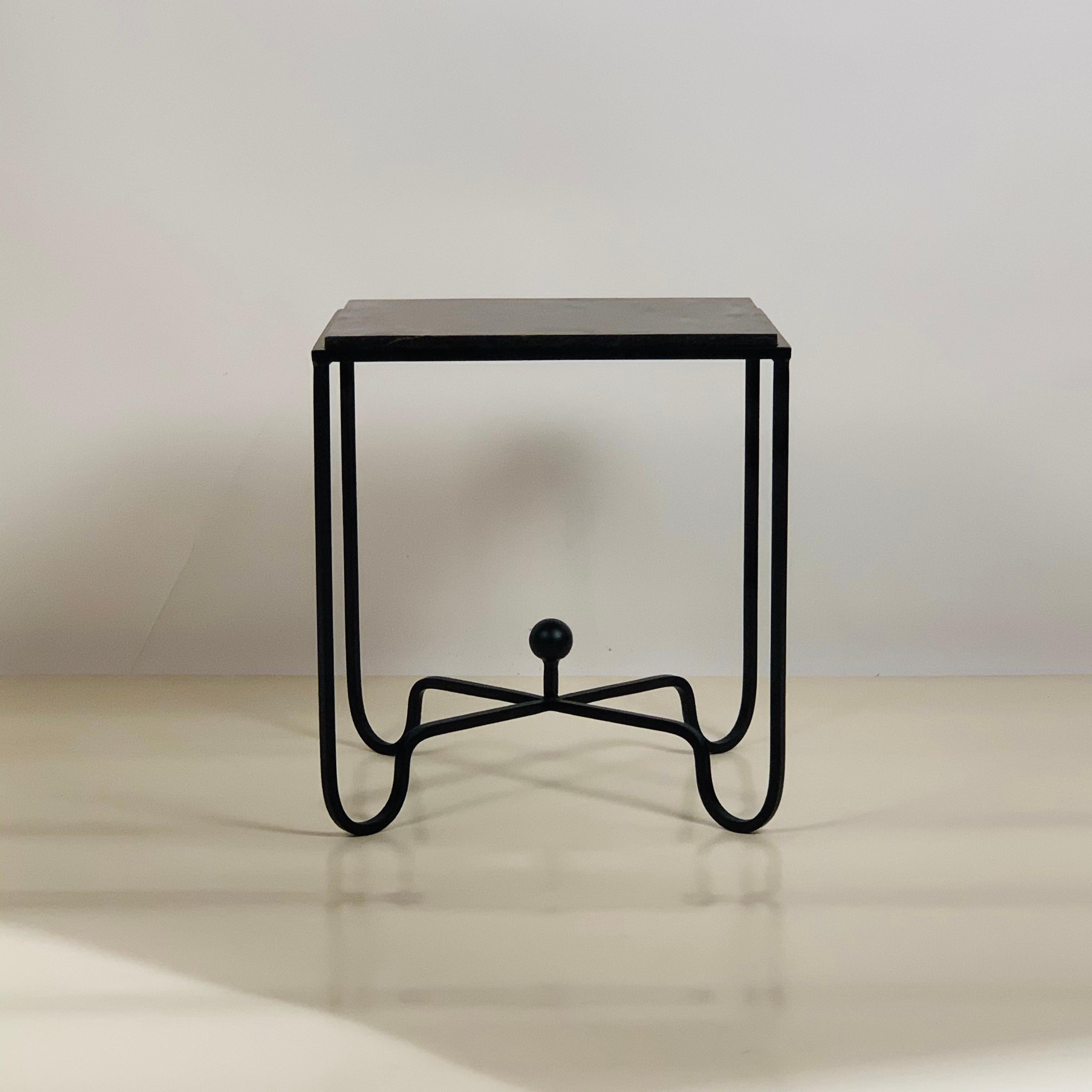 Sculptural blackened steel frame fitted with a gorgeous black limestone top. Very durable stone surface.

Inspired by the timeless aesthetic of French modern design, this side table from our exclusive Design Frères line is handmade in our Los