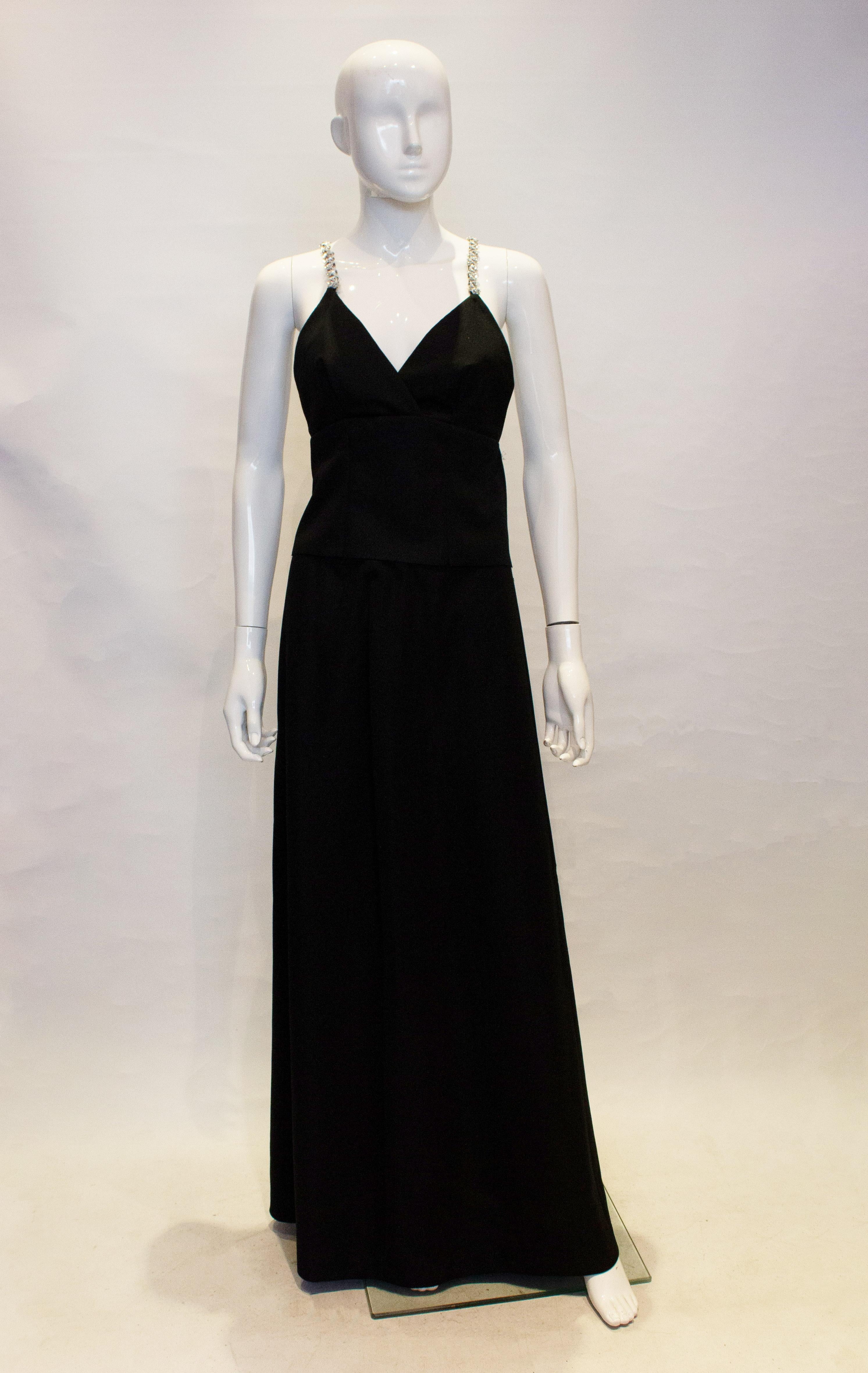 A homemade but headturning two piece from the 1970s. In a black crepe fabric the top has crossover back straps in sequins with a zip fastening. The skirt is A line with a back central zip.
Measurements: Bust 36'', waist 31'' ,length 45''
