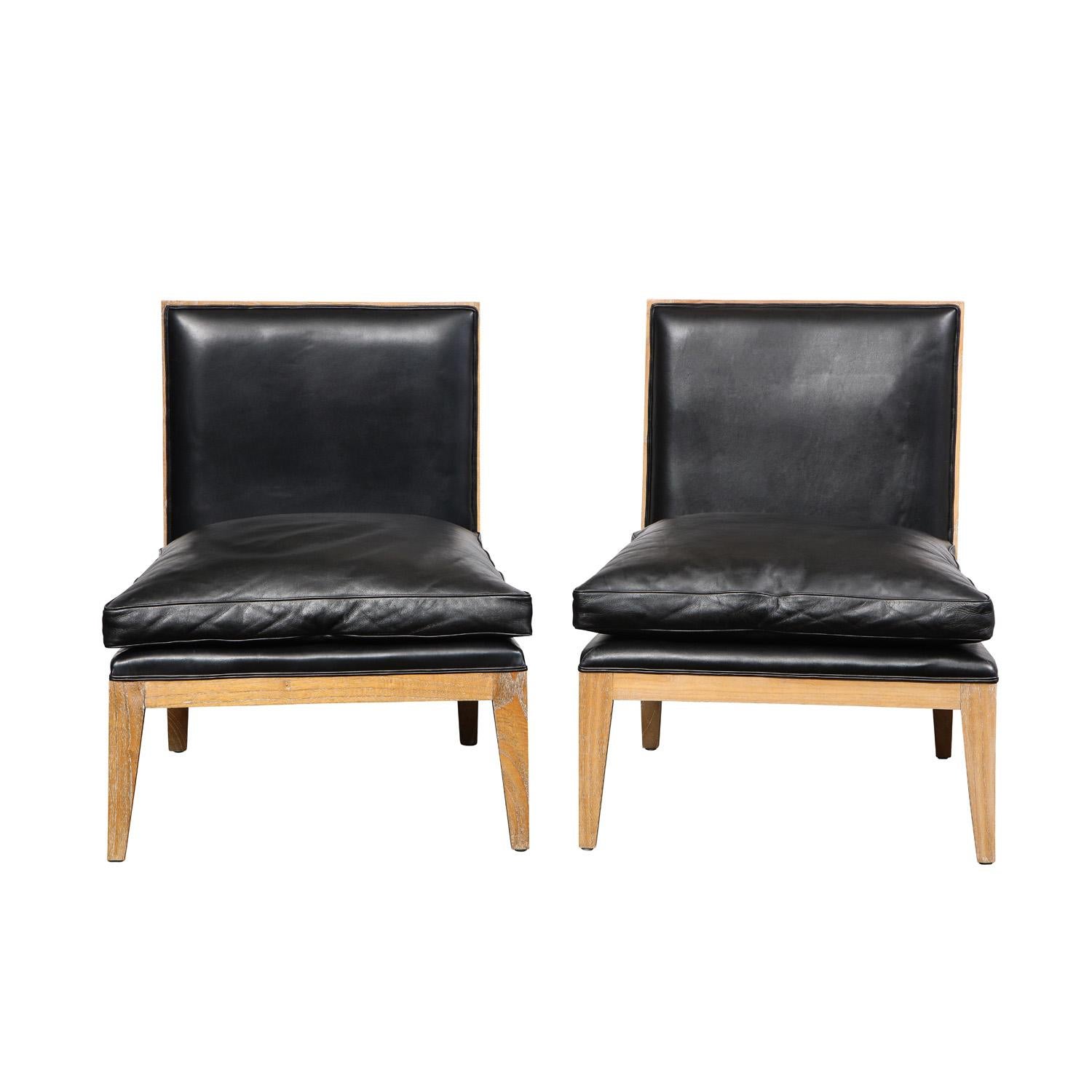 Pair of elegant slipper chairs in cerused oak with black leather seats and back, French 1960's. The combination of materials is very chic. These are beautifully made.