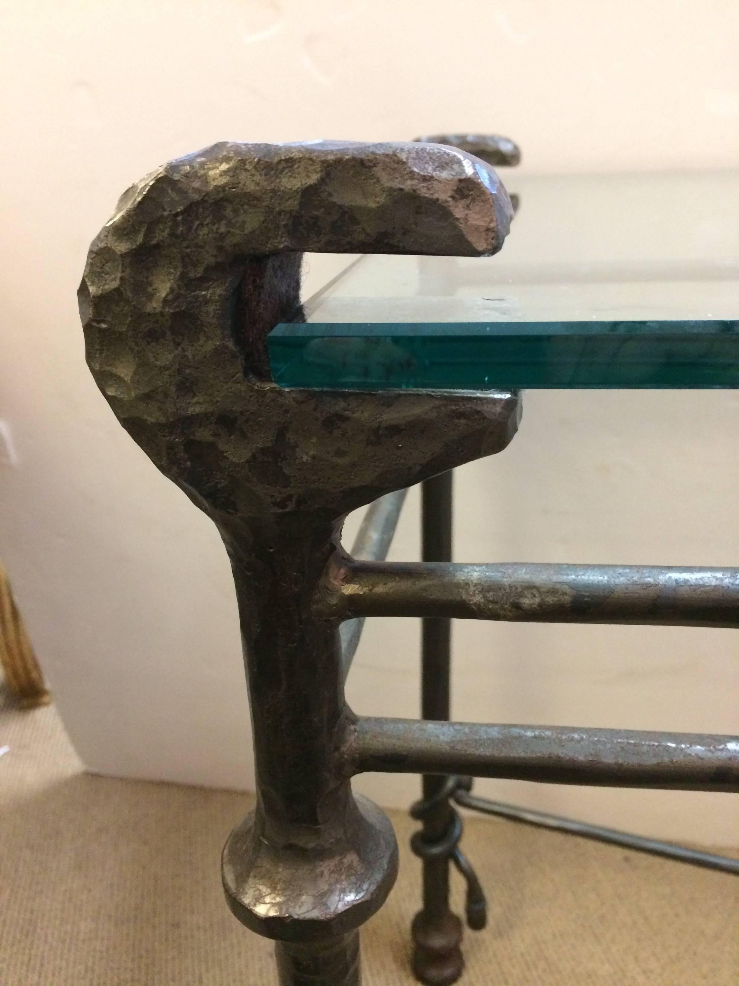 Handsome Italian console table having hand-forged iron base with criss cross and wonderful Giacometti sculptural design as well as a 1/2 inch thick blunt edge piece of rectangular glass. 28 inches to top of glass surface.
NOTE:  Pair of these