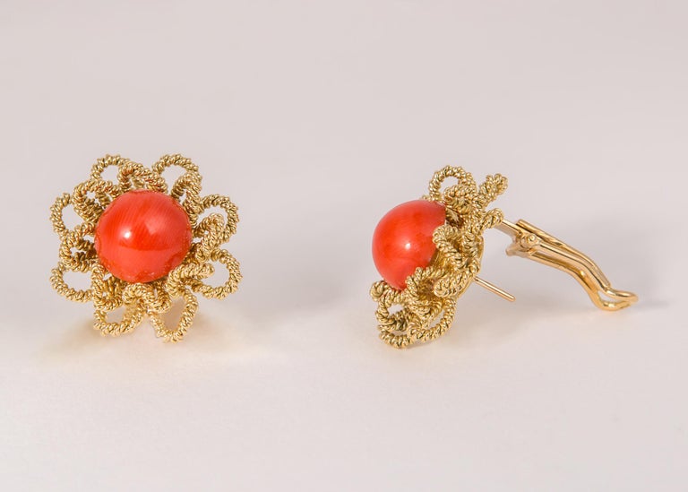The excellence of Italian design and detailing shines through in this playful flower motif earring. A matched pair of 12mm vivid orange coral are framed with petals of 18k gold. 1 inch in size.