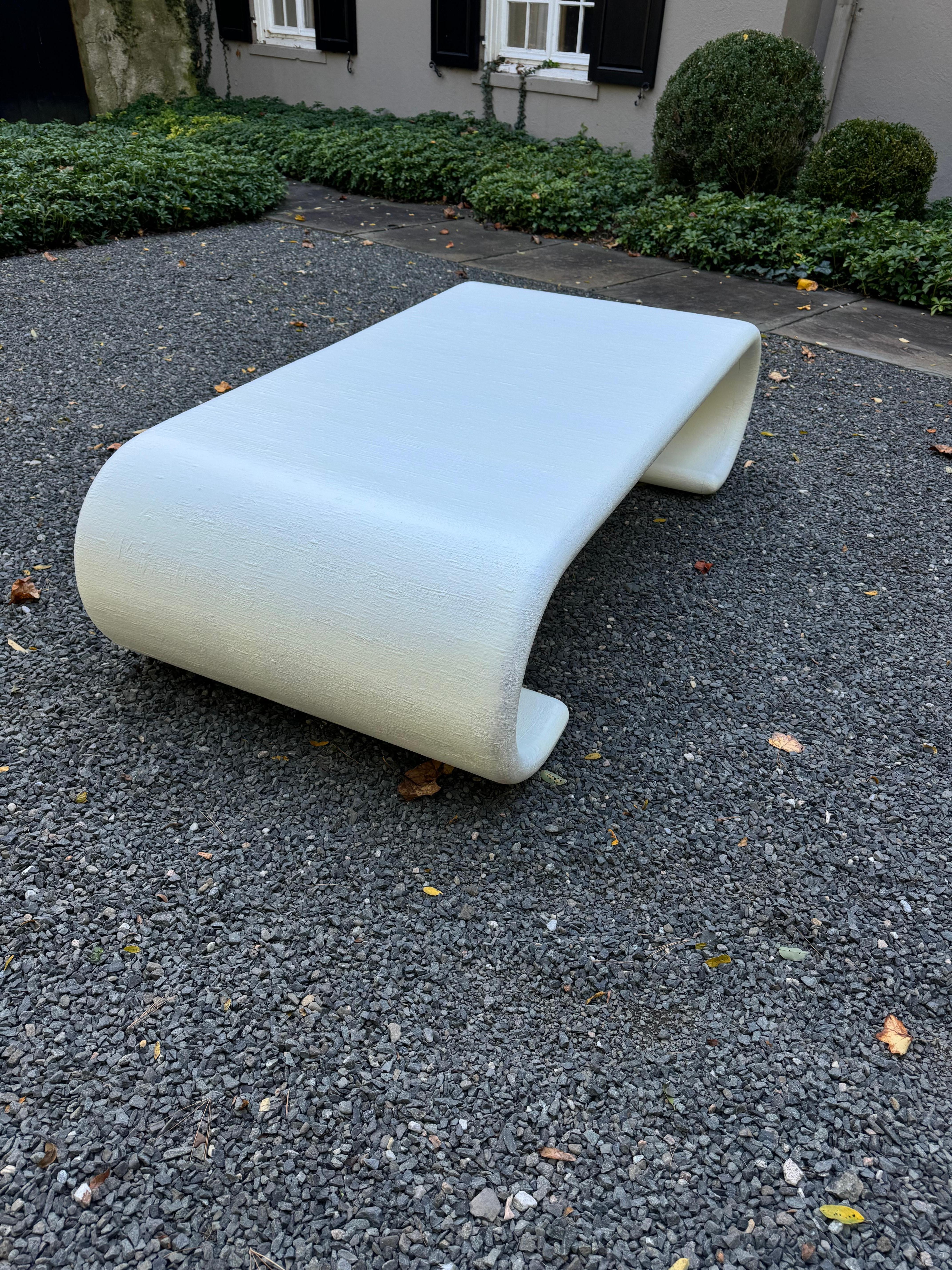 Iconic Karl Springer style mid 20th century scroll coffee table, having linen wrapped wood just freshened up with white paint.