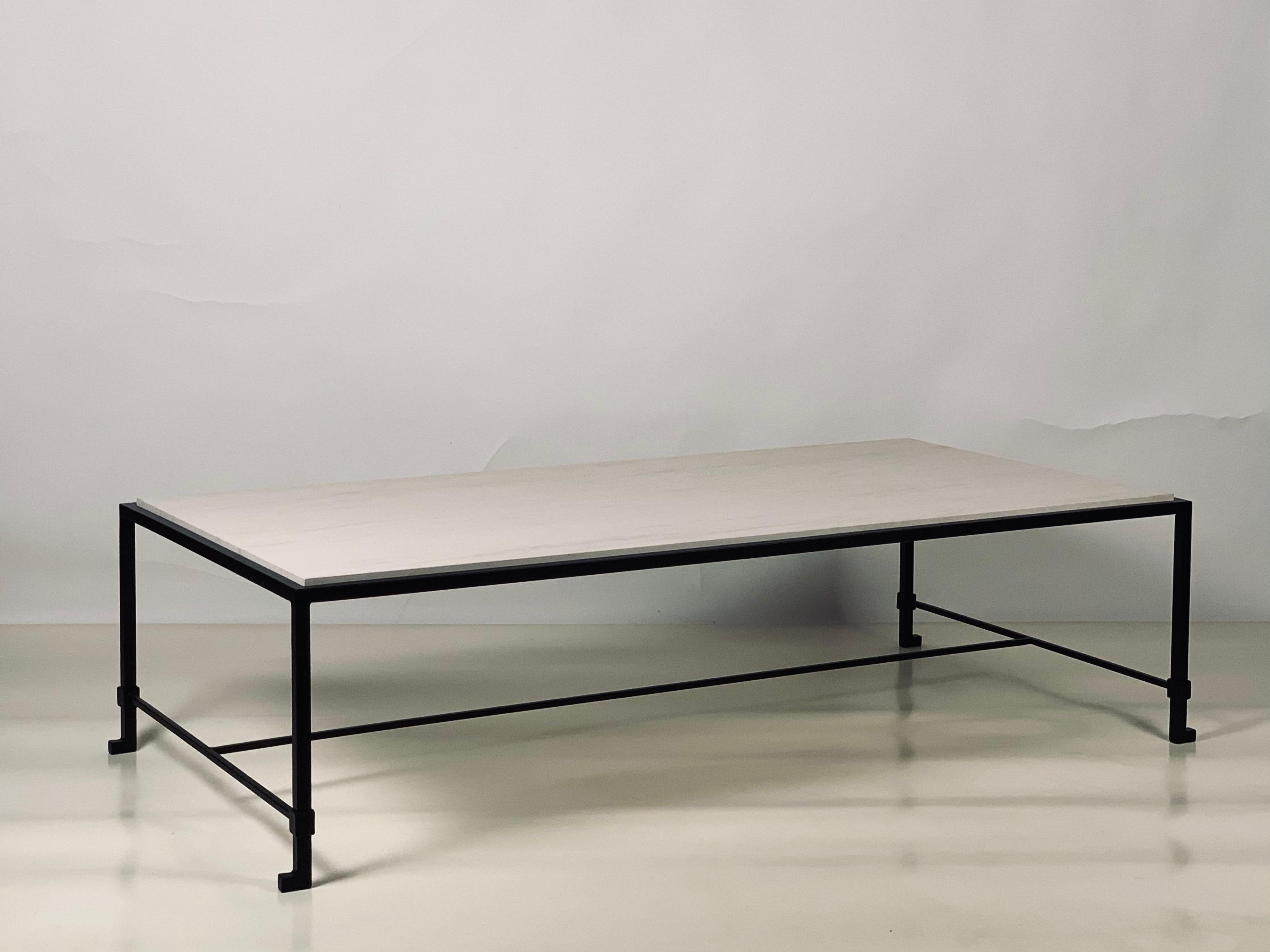 Chic large 'Diagramme' limestone coffee table by Design Frères. Gorgeous honed cream limestone top fitted into a slender but sturdy iron frame.

Inspired by the timeless aesthetic of French modern design, this coffee table from our exclusive