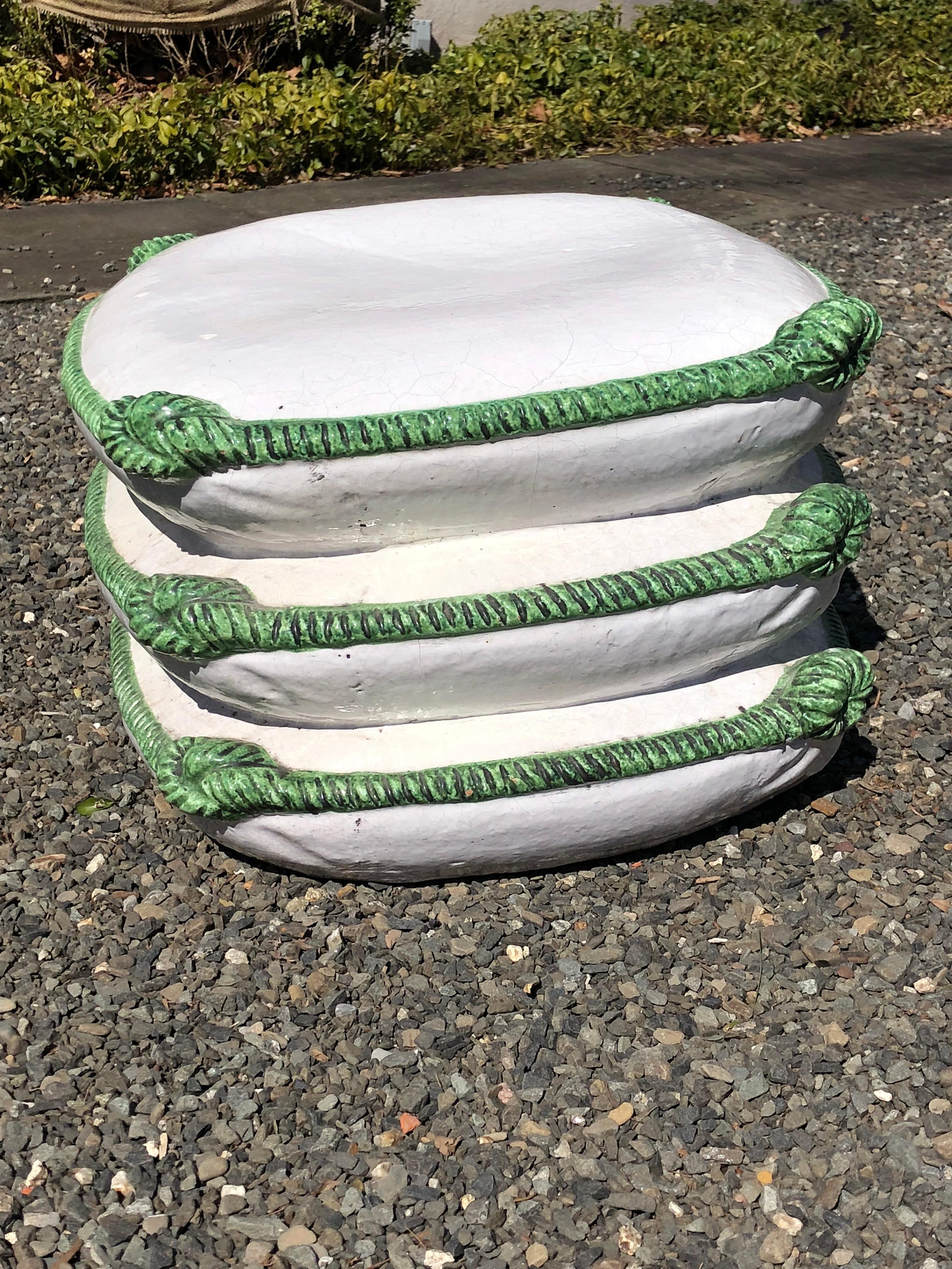 Unique pillow form Majolica garden seat in white ceramic with emerald green roping and knots. The color combination of this piece of Majolica is quite striking and would look great both in the garden or indoors.