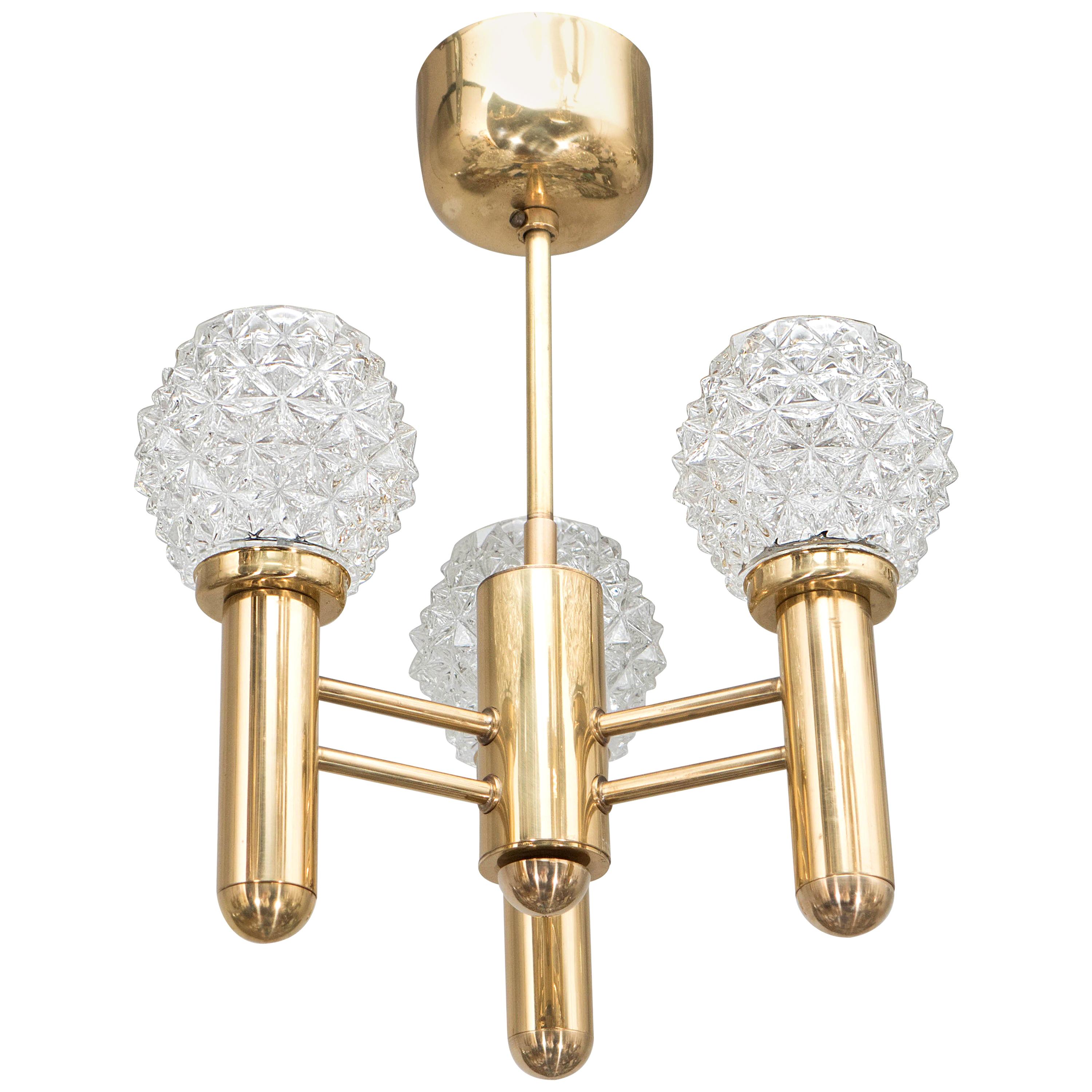 Chic Mid-Century Modern Three-Arm Brass Chandelier with Faceted Glass Globes