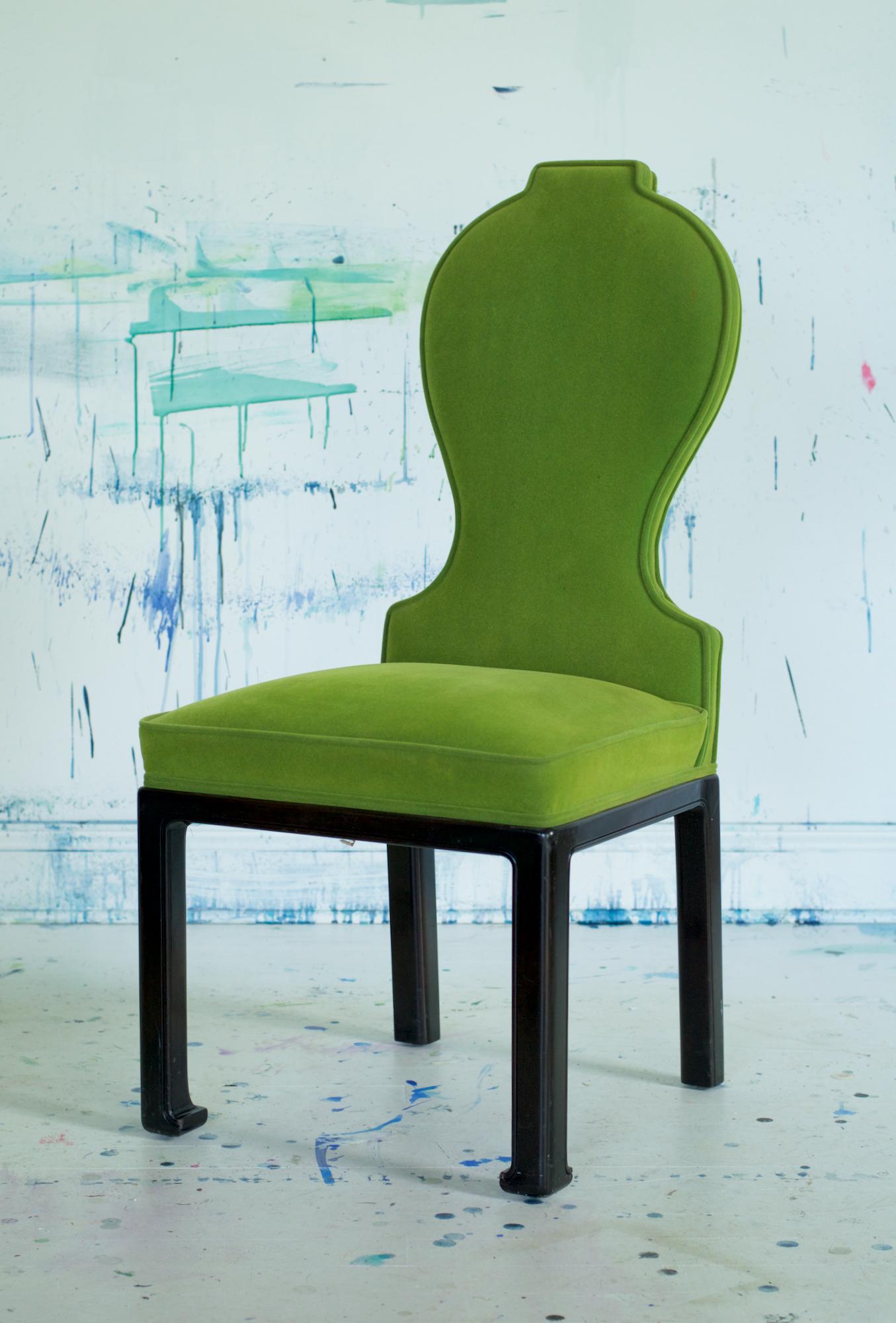 A set of elegant and chic dining chairs having modernist spoon backs and simple ming inspired leg conformation. The late 1970s vintage chairs are dressed in an incredibly vibrant rich green contract grade short pile mohair which is most likely