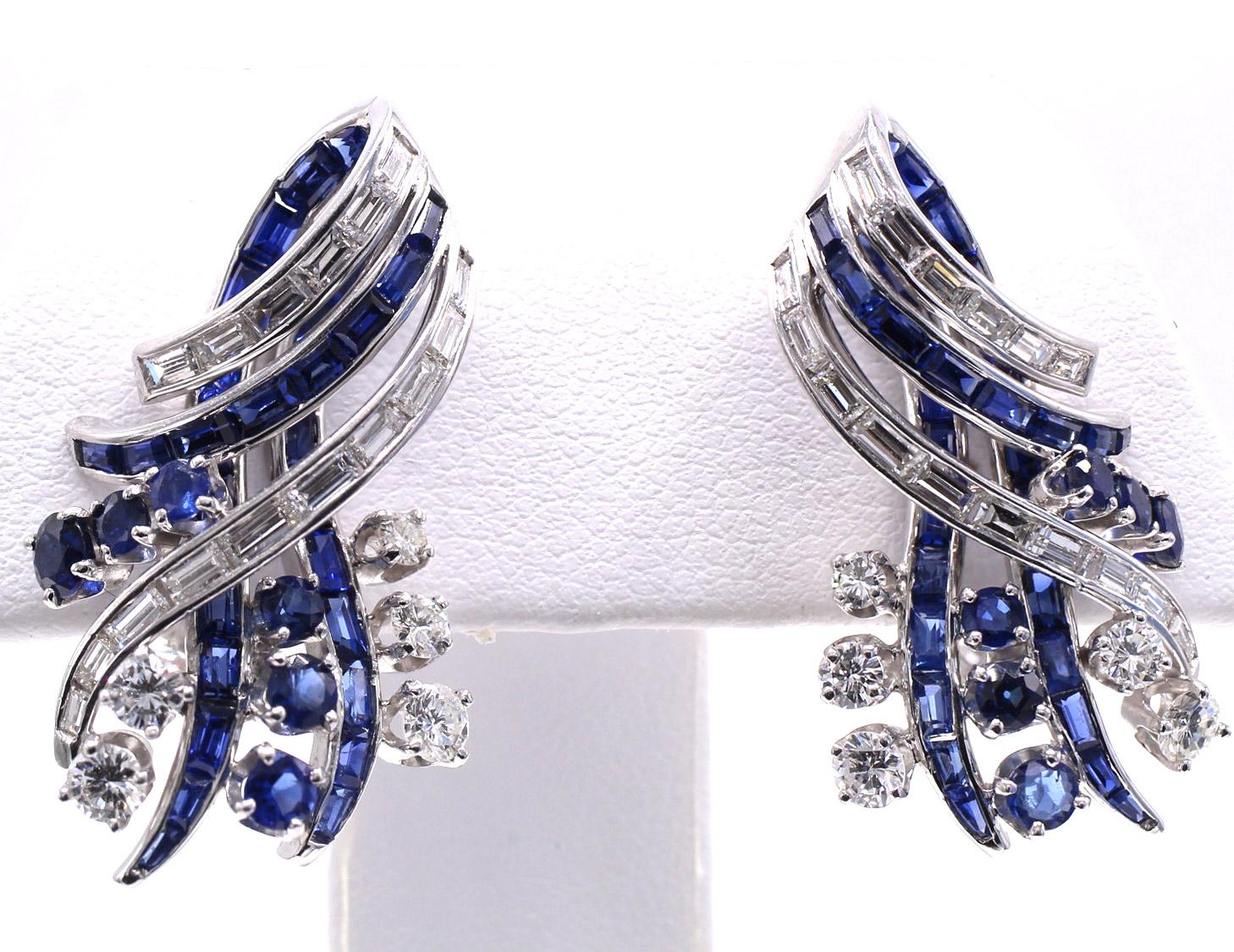 These chic and most wearable 1970s ear clips by Nieman Marcus have a wonderful abstract and three dimensional design, finely crafted in platinum. Loops of channel set diamond and sapphires adorn the top of this clips while prong set and some channel