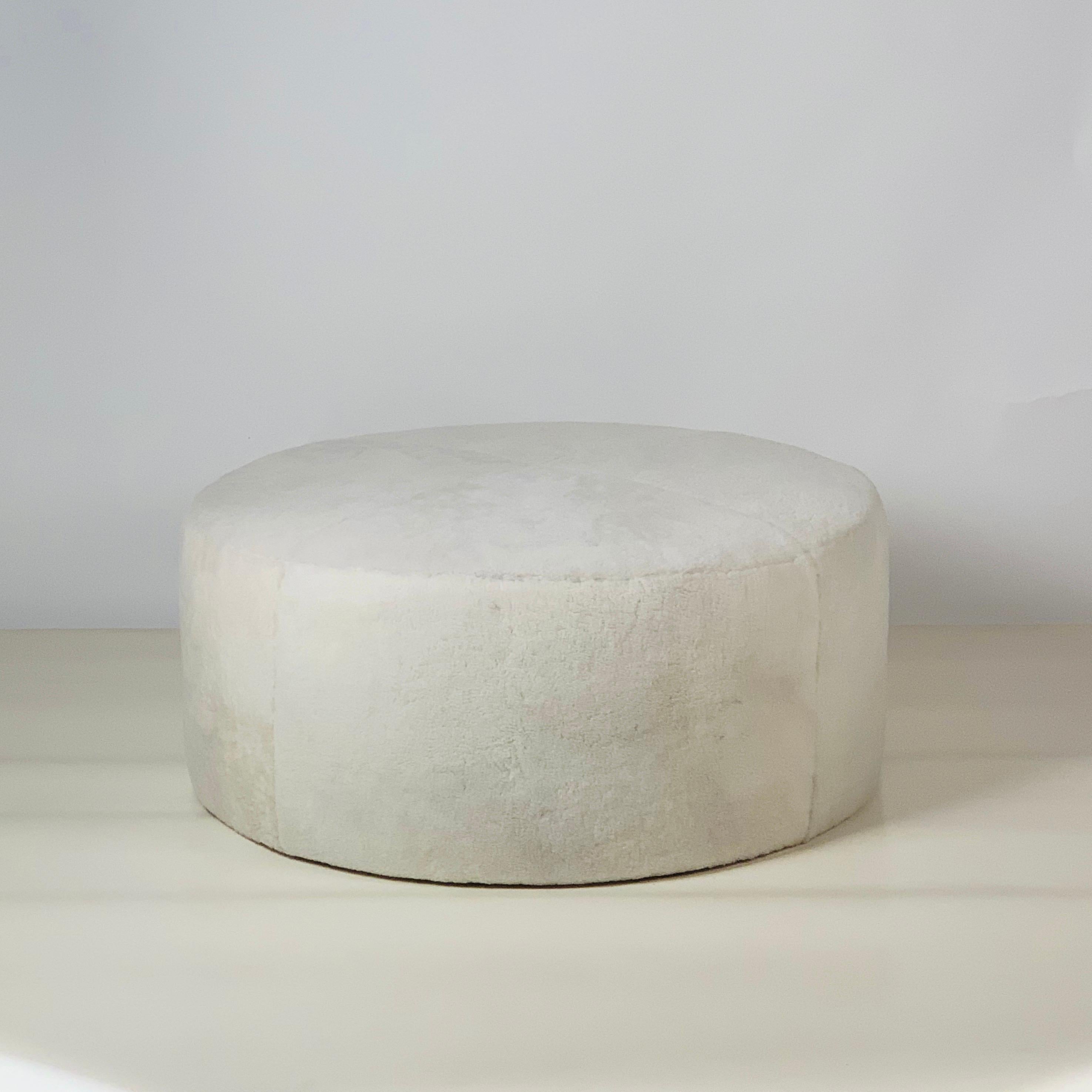 Chic 'Ours Polaire' ottoman by Design Frères.

Beautiful natural shearling round ottoman. Upholstered firm to be used as seating and as a table surface for trays, bags, books, etc.

Inspired by the timeless aesthetic of French modern design,