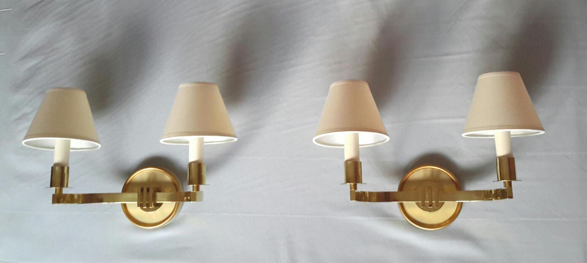 Very elegant pair of French Mid-Century Modern 2-arm (double) wall sconces from the mid-1950s, in bronze, cream white lacquered metal and ivory cotton shades. The lamp shades are brand new. The electrical part has been newly redonne and fits the