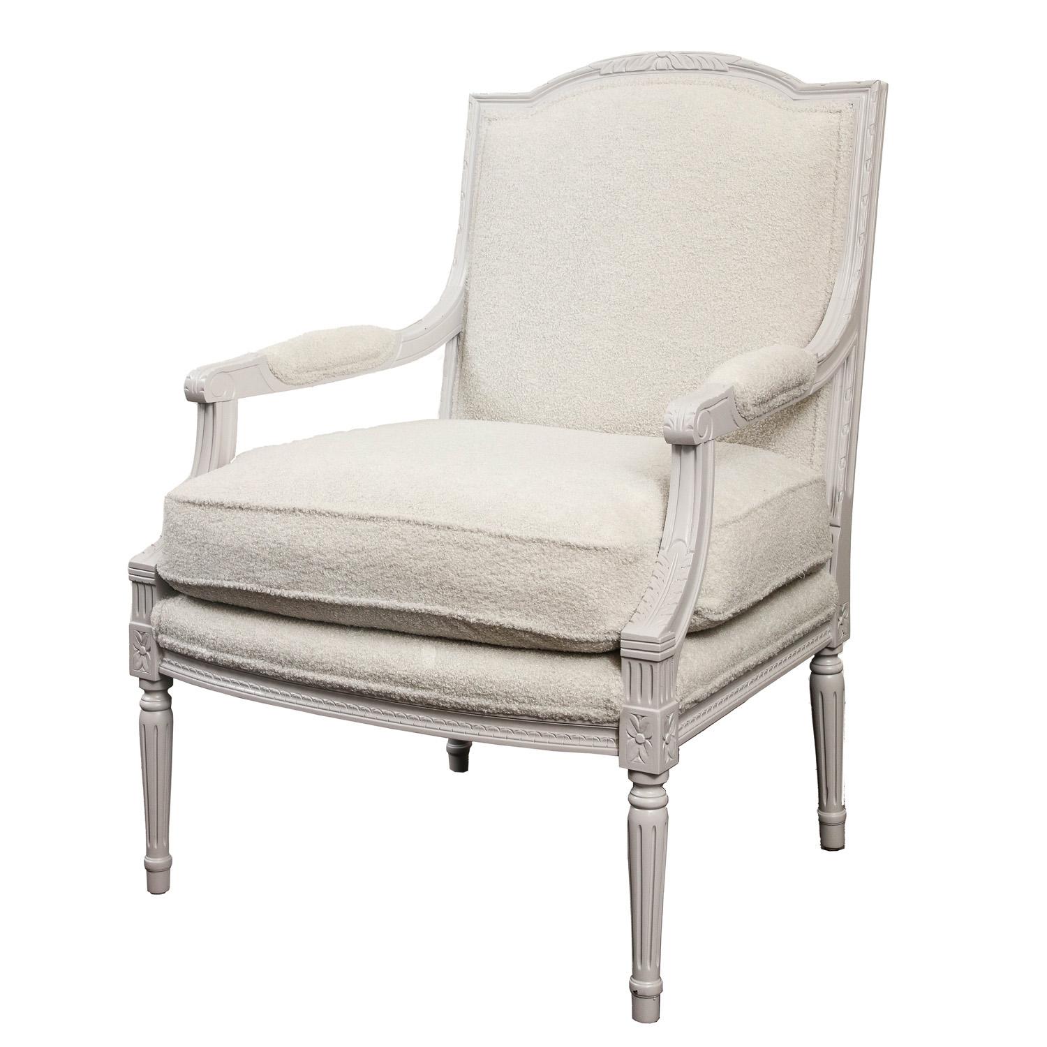 Louis VI style pair of painted arm chairs newly upholstered in pearl color boucle fabric.