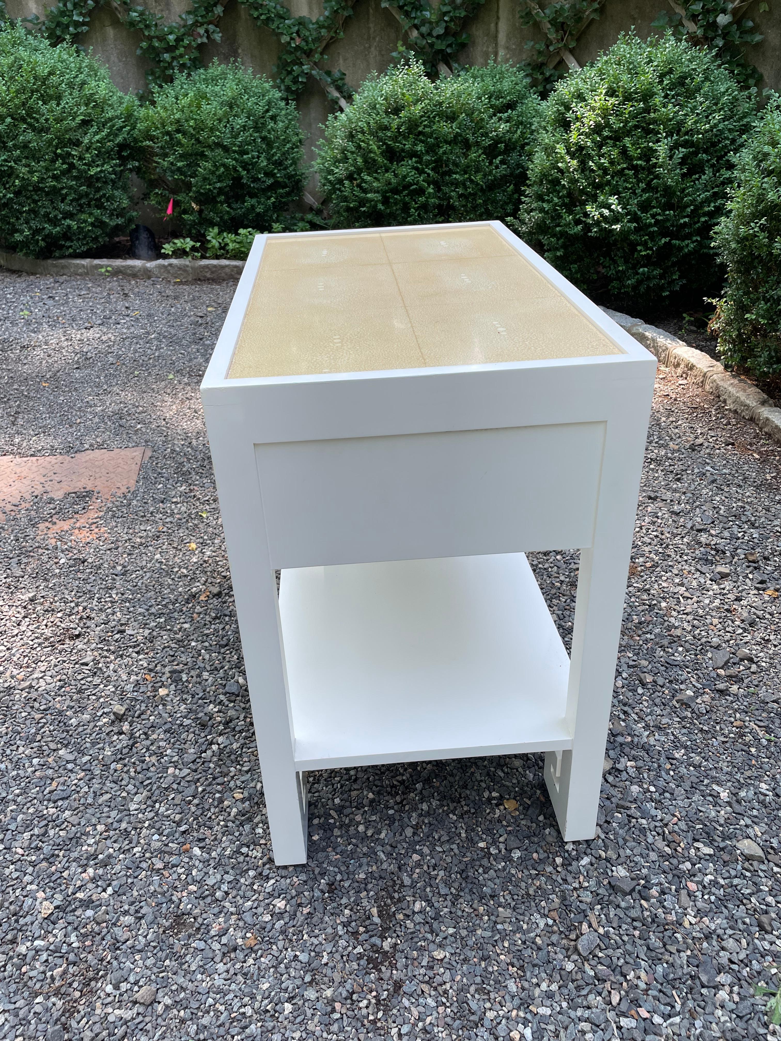 Handsome pair of white laquered bedside tables with smooth contrasting top and wonderful shaped feet in the traditional Chinese style.  The clean lines and single drawer with nickel hardware make these tables versatile and sophisticated.