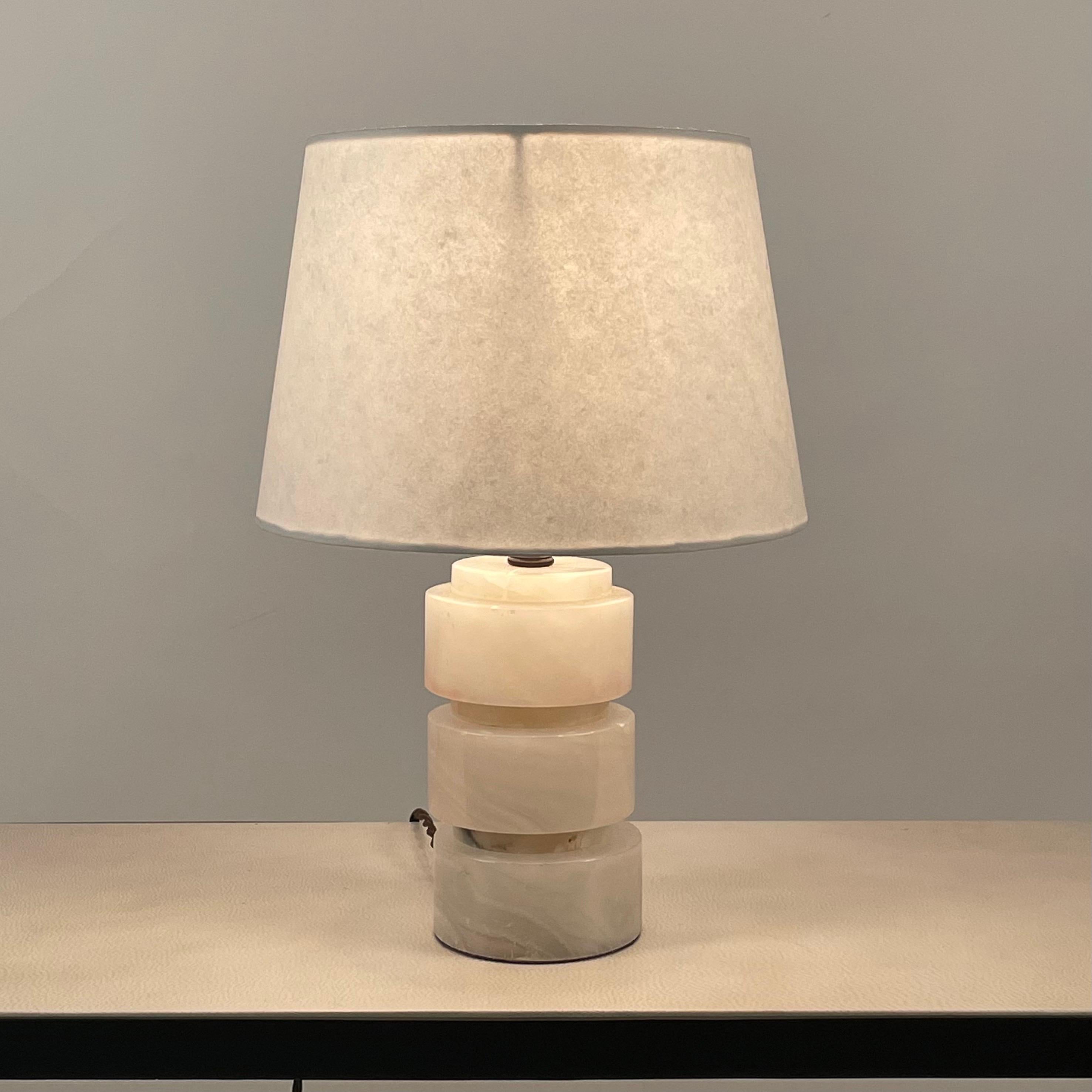 Chic polished alabaster Art Deco table lamp. Rewired with new parchment paper shade.

Perfect where a smaller, understated lamp is desired.

Dimensions listed are the overall dimensions of the lamp with the shade in place.