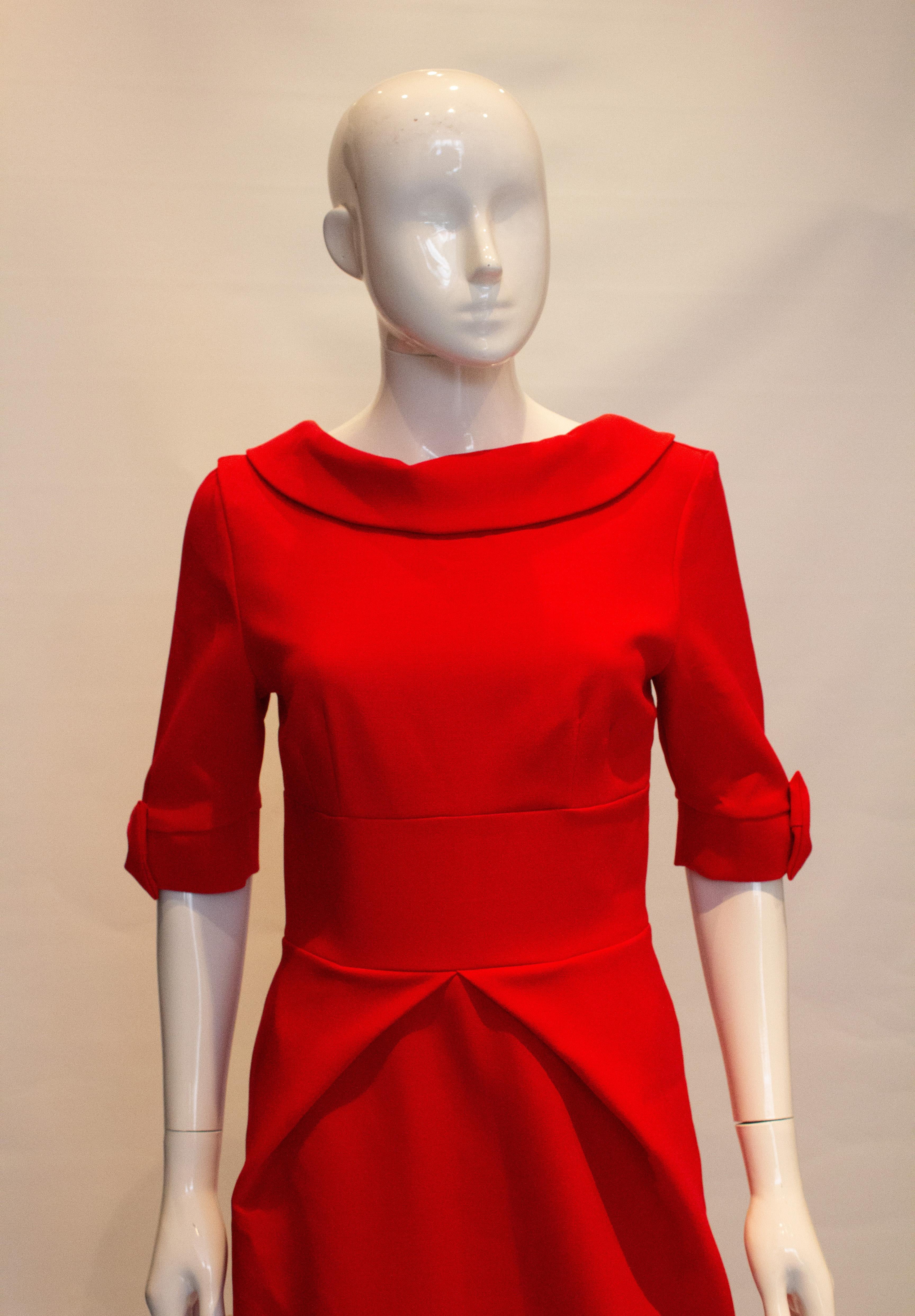 A great dress for the festive season, by the Pretty Dress Company.  The dress has a wide collar, v backline  and elbow length sleaves with bow detail. It is fully lined and has a central back zip opening. Marked size 10.
Measurements: Bust 36'',
