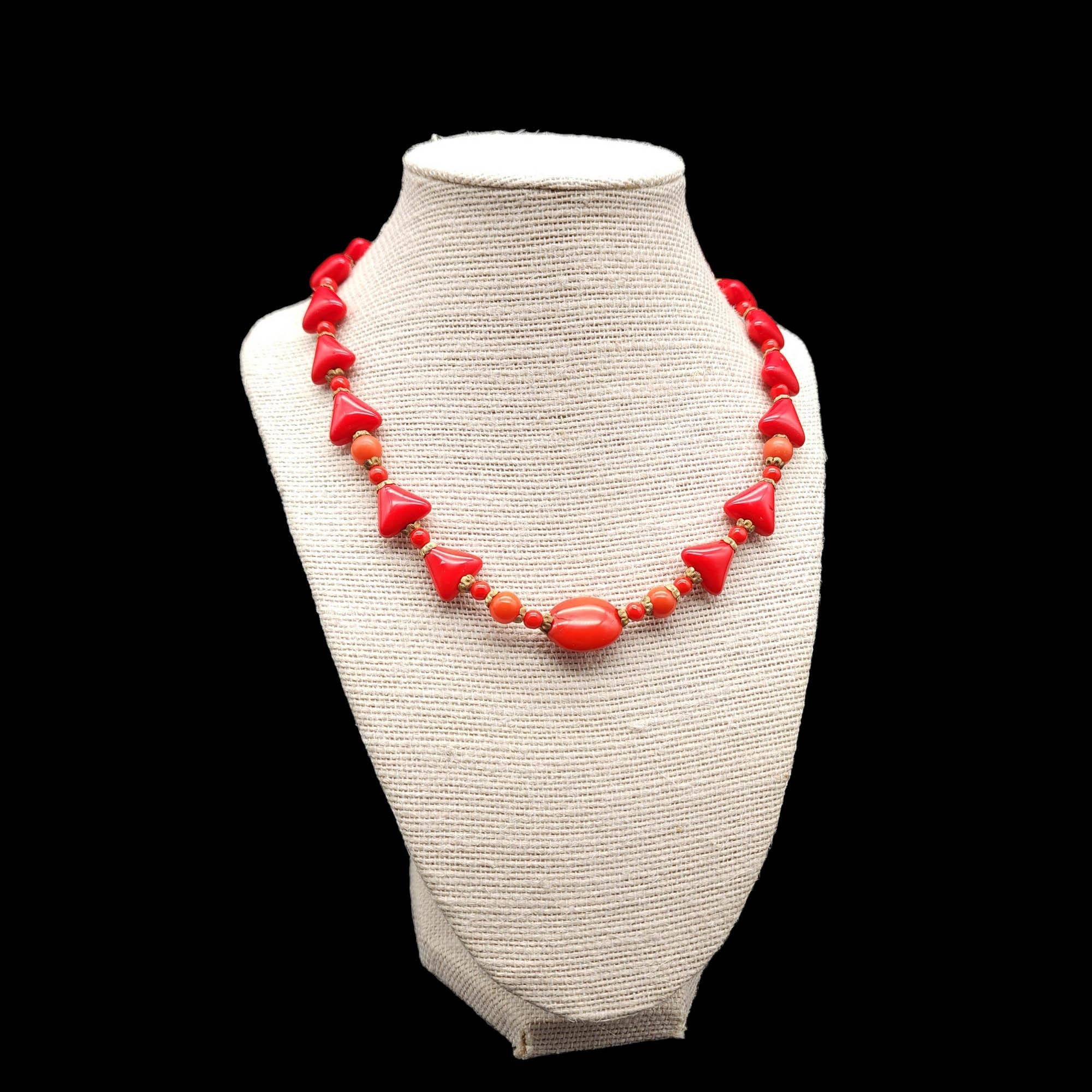 Necklace length: 42 cm / 16.5 inches - Collar / Choker Style

Step into a world of classic glamour with this red Lucite necklace. This exquisite piece features a striking combination of triangle and round beads, each delicately adorned with