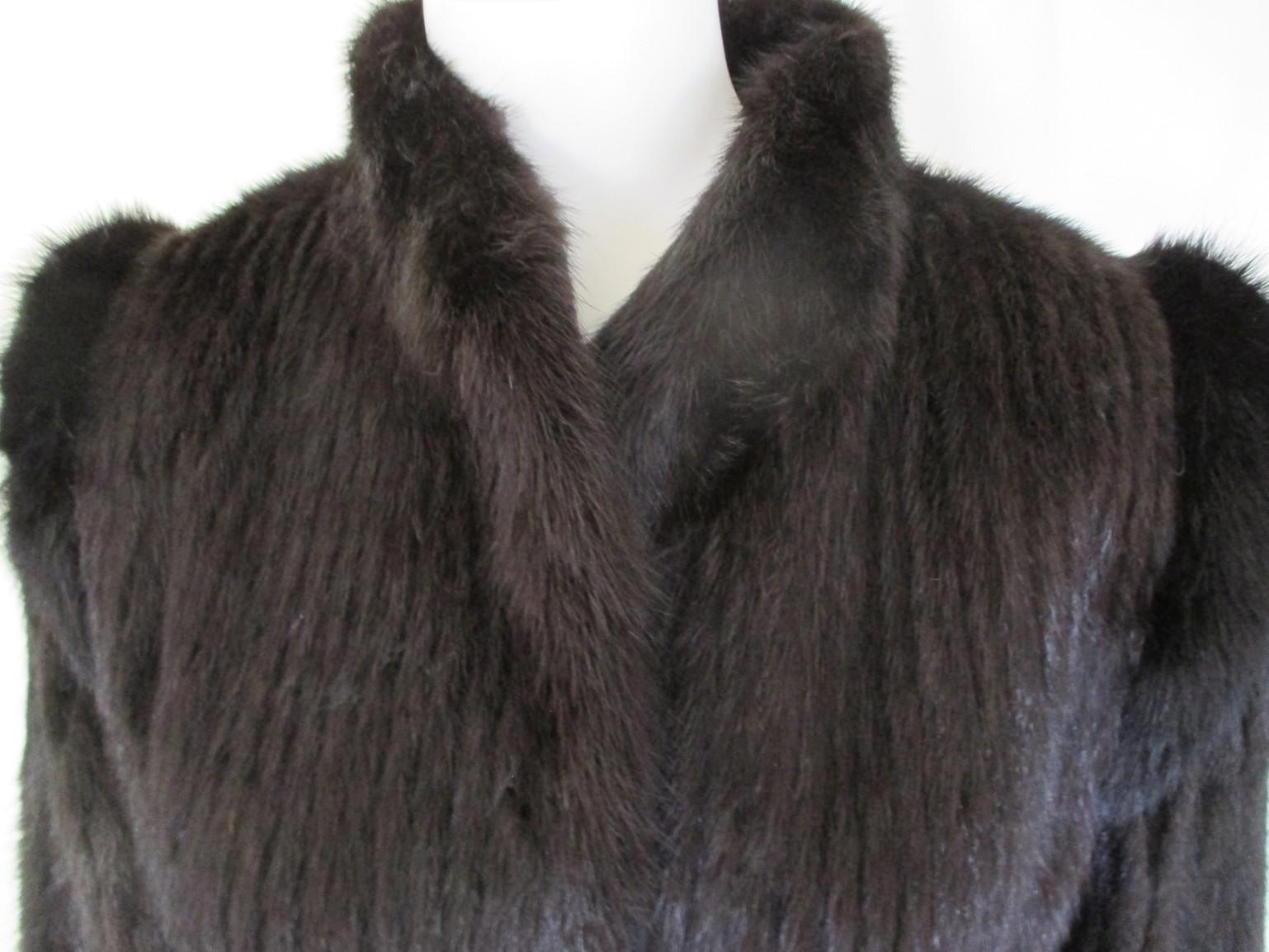 This vintage jacket is made of mink fur, made by Saga mink (Saga furs, superior fur products)
Color:  dark brown to black
It has 2 pockets, 2 closing hooks and fully lined.
Size fits as aprox. US 6-8 / EU 38, see section measurements.
Good pre-owned