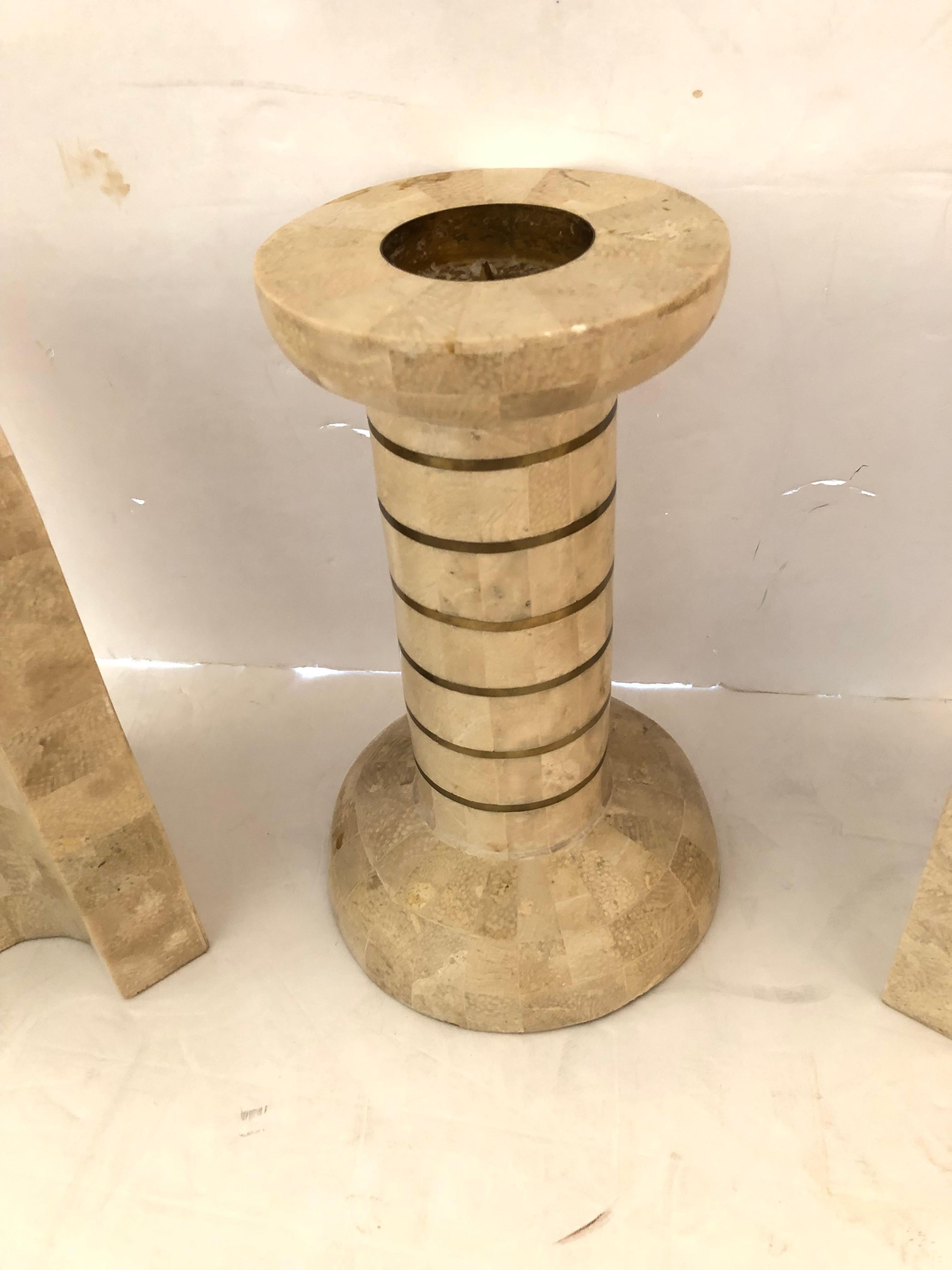 Chic mid-century set of bookends and matching chunky candlestick beautifully made of tessellated stone. Makes a stylish accessory set.
Candlestick 9.25 h 4.5 round at top; 5.75 round base
Bookends  5 w 4.5 d 9 h each