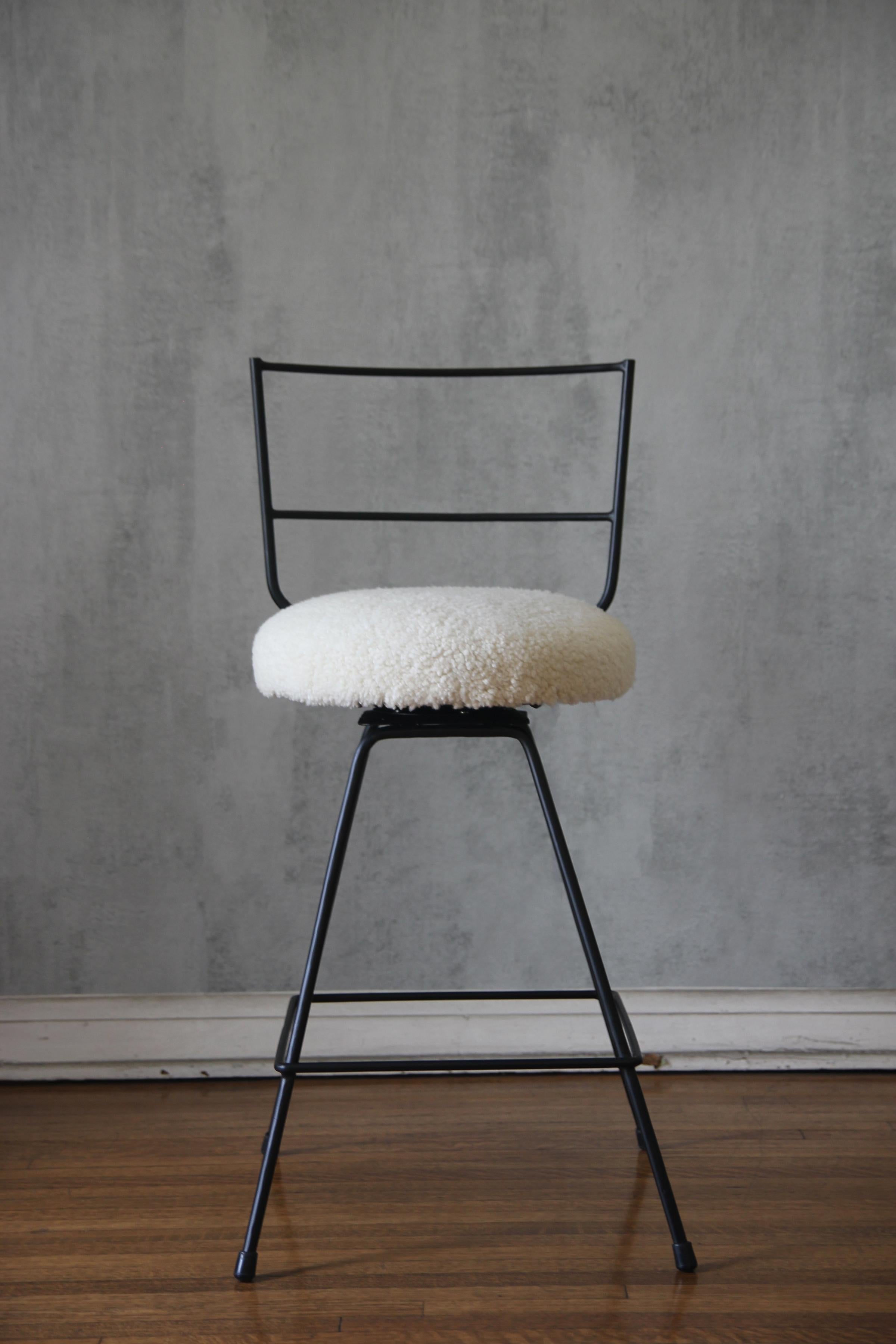 This unique upholstery treatment gives a luxurious feel. Chic combination of slender but sturdy powder coated steel frames contrast nicely with the natural cream shearling upholstery.

The stool is part of our new Understated Design line and can