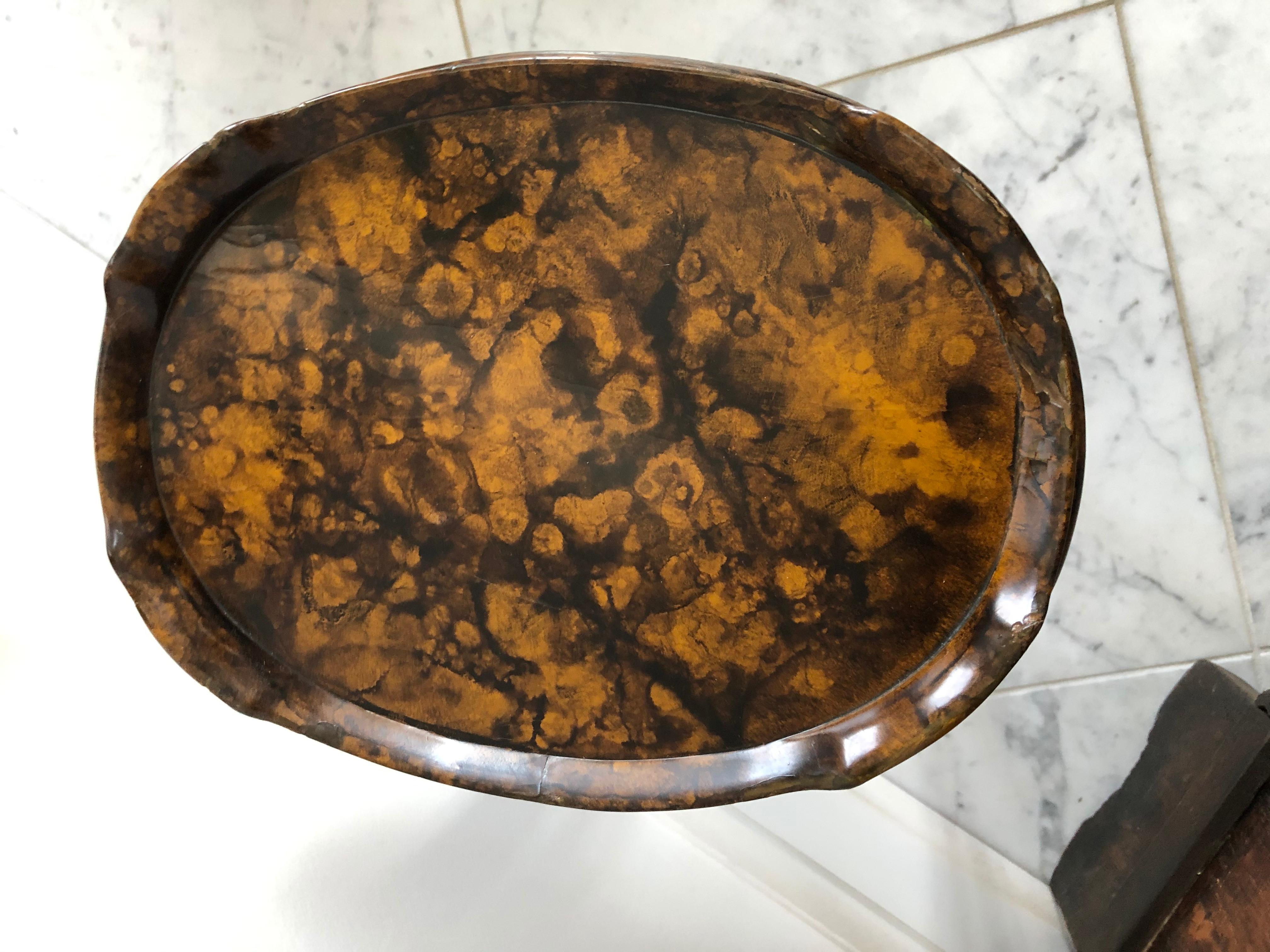 A jewel of a drinks table in a tortoise shell finish. The table has great patina and is the perfect size to place a martini.