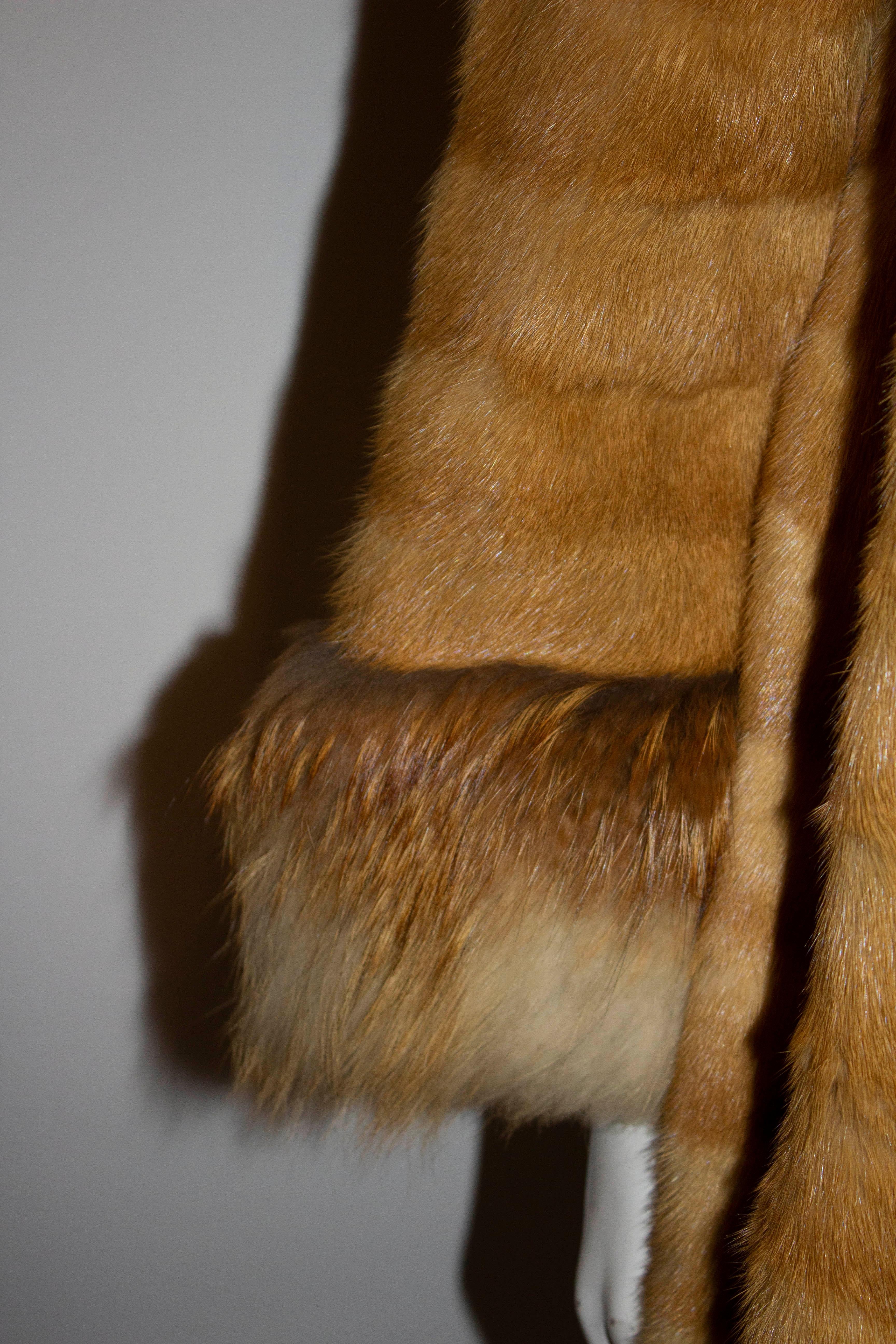 A headturning vintage fox coat from the National Fur Company. The coat has wide fur detail on the hem , cuffs and collar and has a button opening. It is fully lined and has one side pocket.

Measurements: Bust 38'', length 39'', shoulder to shoulder