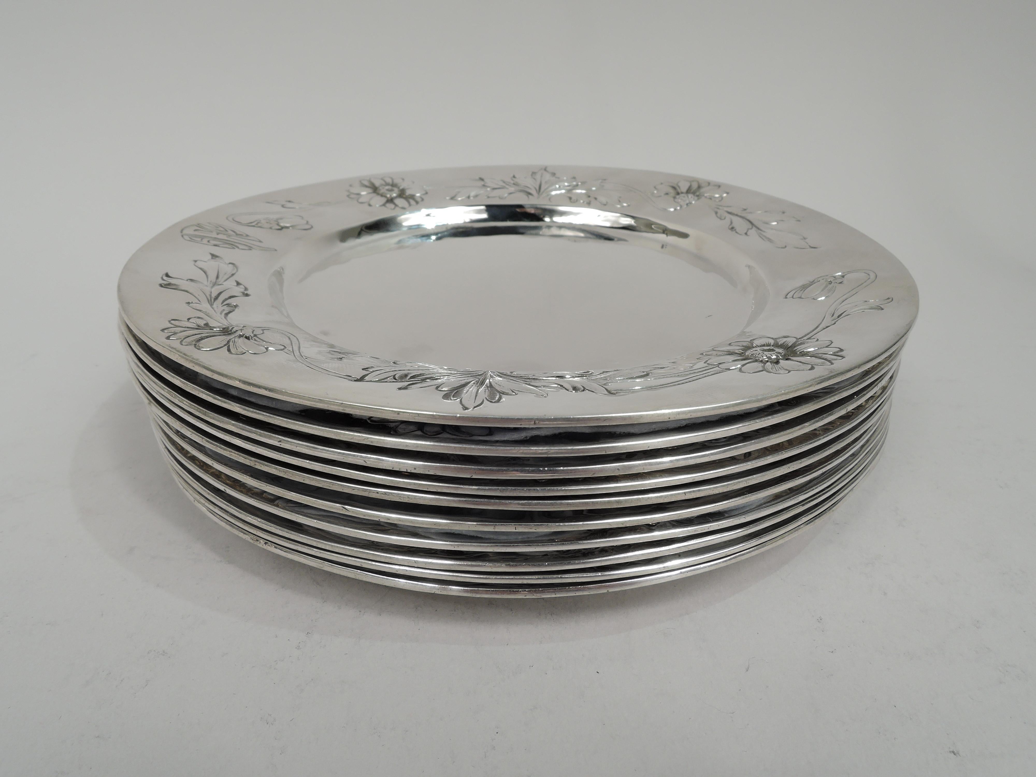 Set of 10 Art Nouveau Craftsman sterling silver bread and butter plates. Made by Lebolt & Co. in Chicago, ca 1910. Each: Round well and tapering shoulder with chased and engraved loose flowers and leaves as well as stylistically integrated 3-letter
