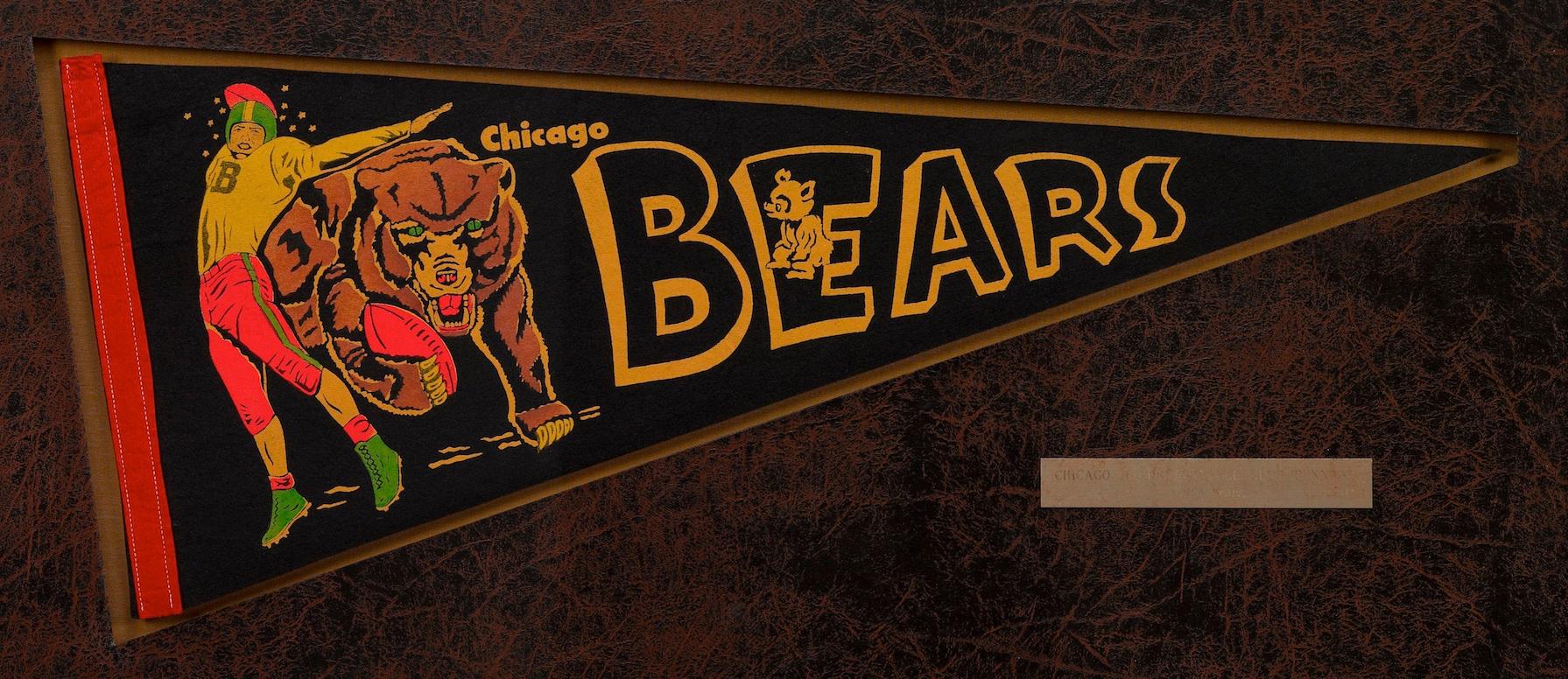 Presented is an original Chicago Bears football pennant, circa 1950. This felt pennant clearly portrays the team name Bears in yellow block lettering. A team member is pictured on the left and appears to be pushed aside from a bear that rushes