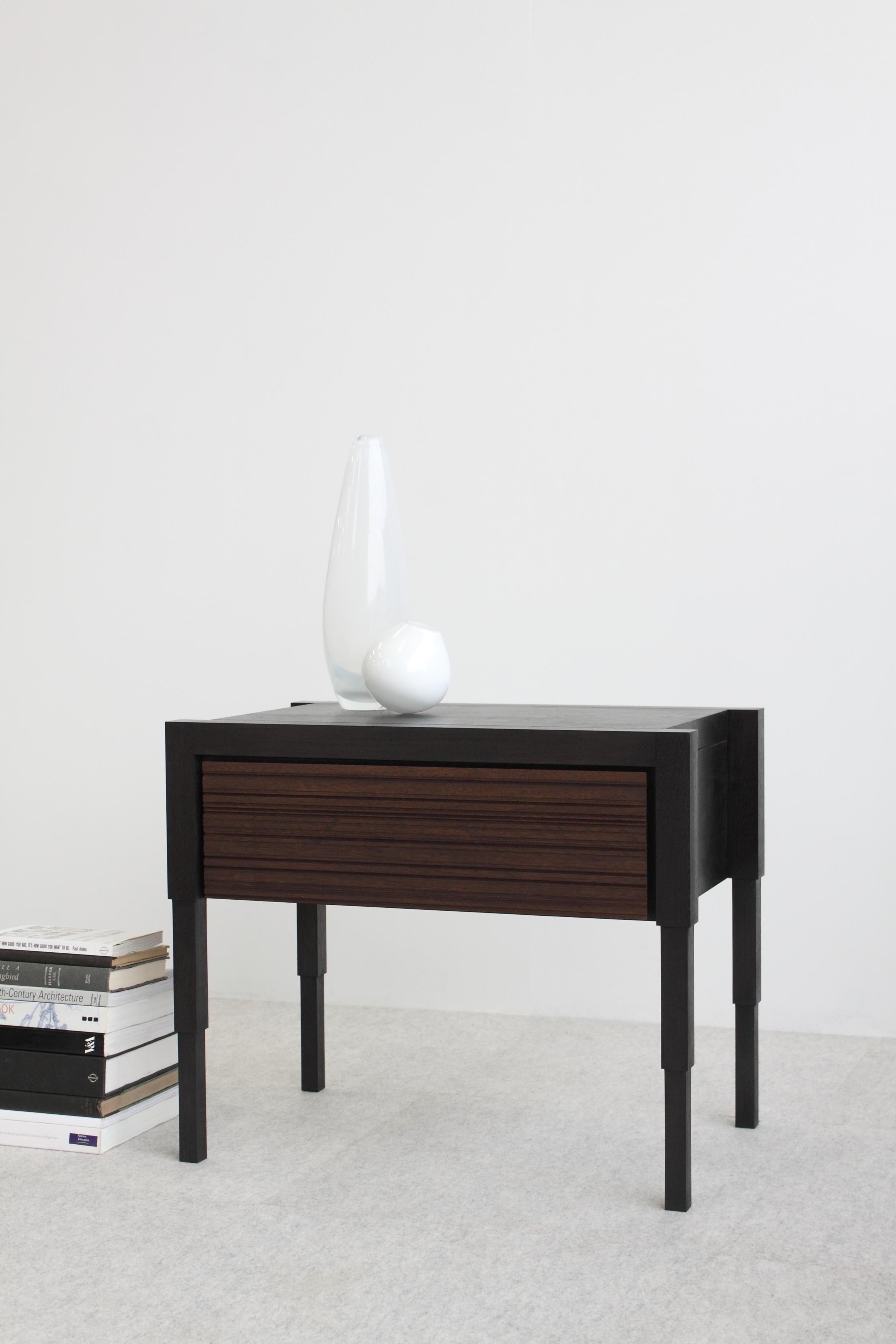 Careful consideration to detail is the acme to the design of this architecturally inspired side table or nightstand. Each table is fabricated by hand and available to order in 8 solid or combination traditional wood finish options.  
Design features