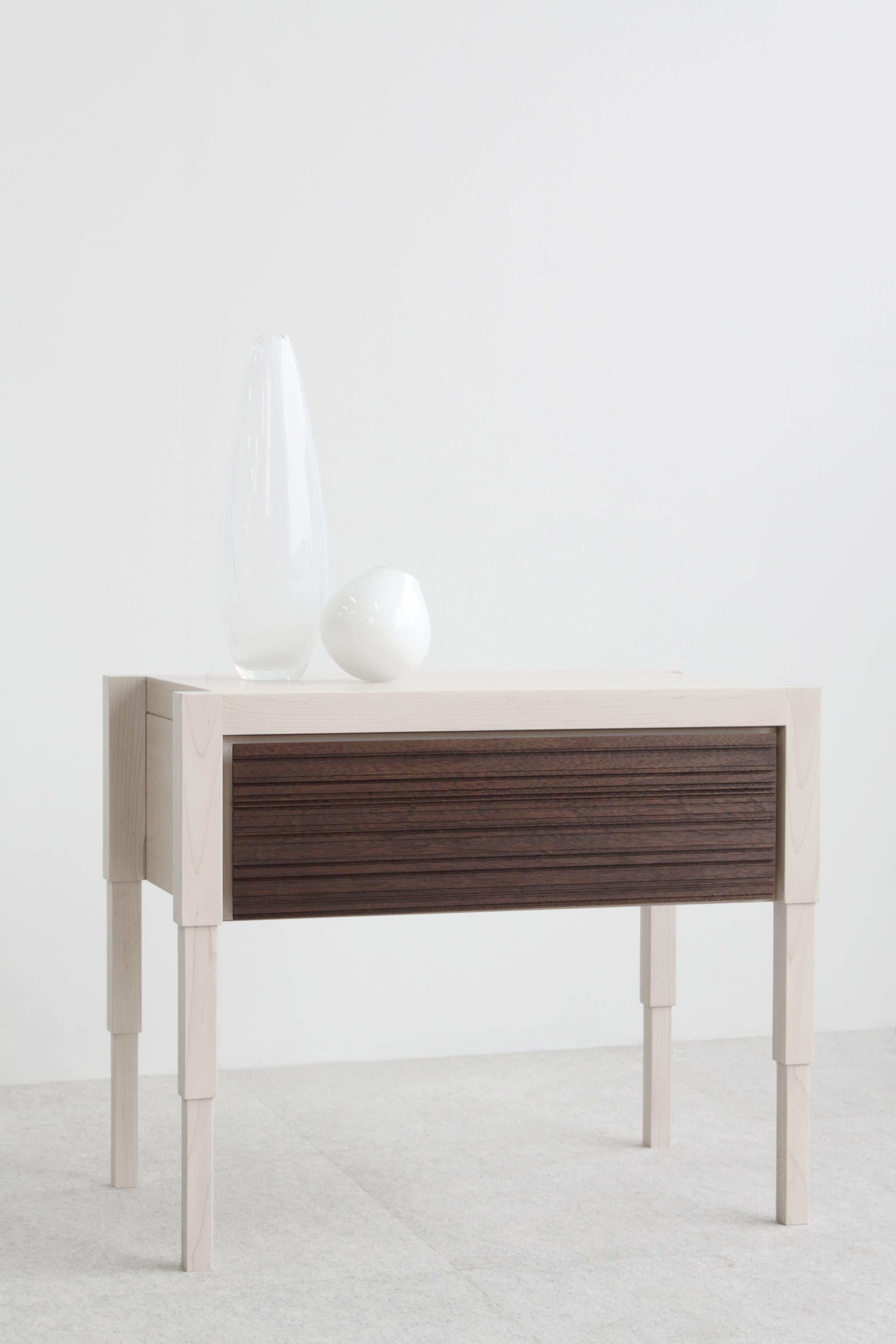 Careful consideration to detail is the acme to the design of this architecturally inspired side table or nightstand. Each table is fabricated by hand and available to order in 8 solid or combination traditional wood finish options.  
Design features