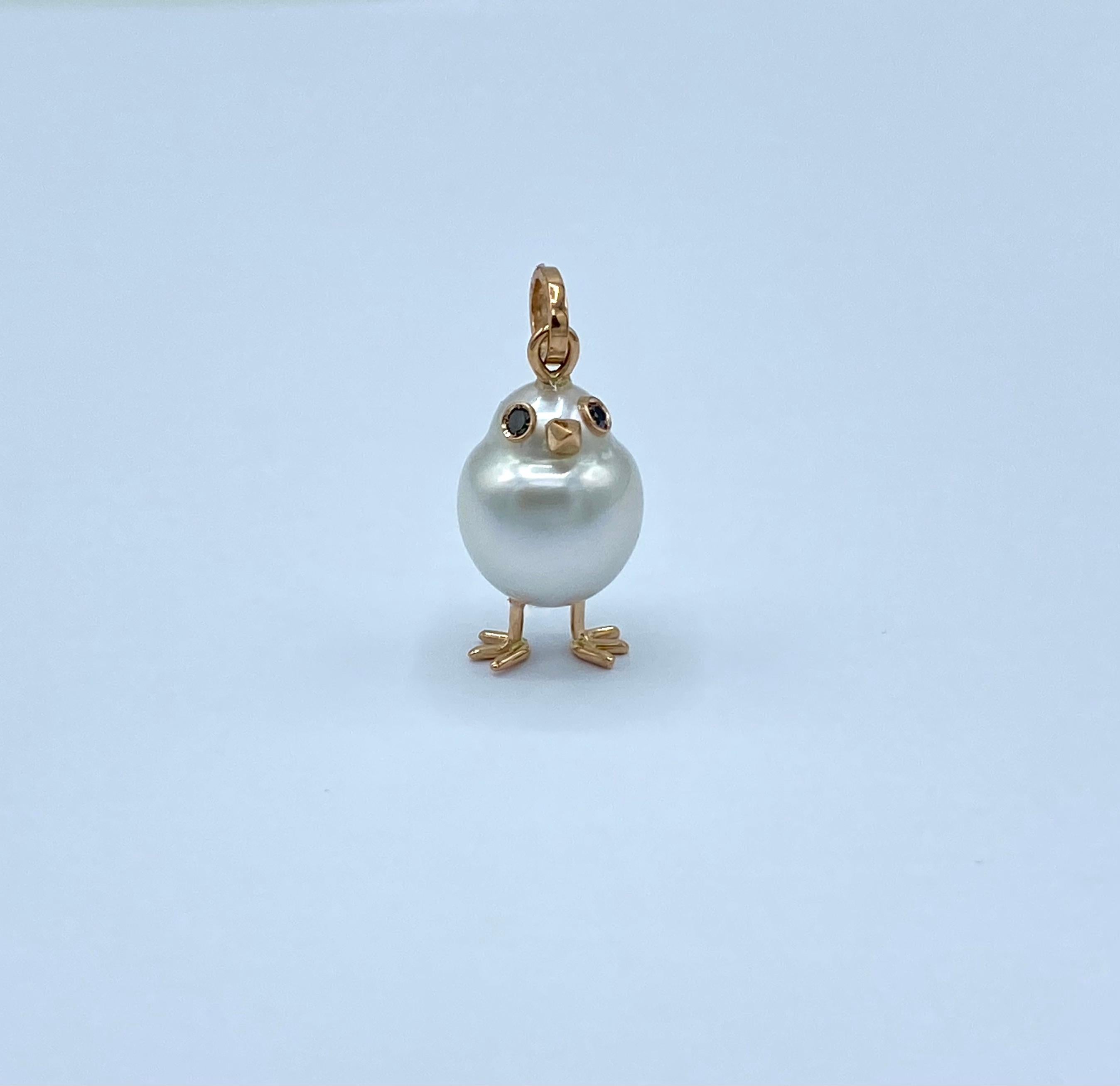 Chick Australian Pearl Diamond Red 18 Kt Gold Pendant or Necklace
A oval shape Australian pearl has been carefully crafted to make a chick. He has his two legs, two eyes encrusted with two black diamonds and his beak. 
The gold is red.
The chain is