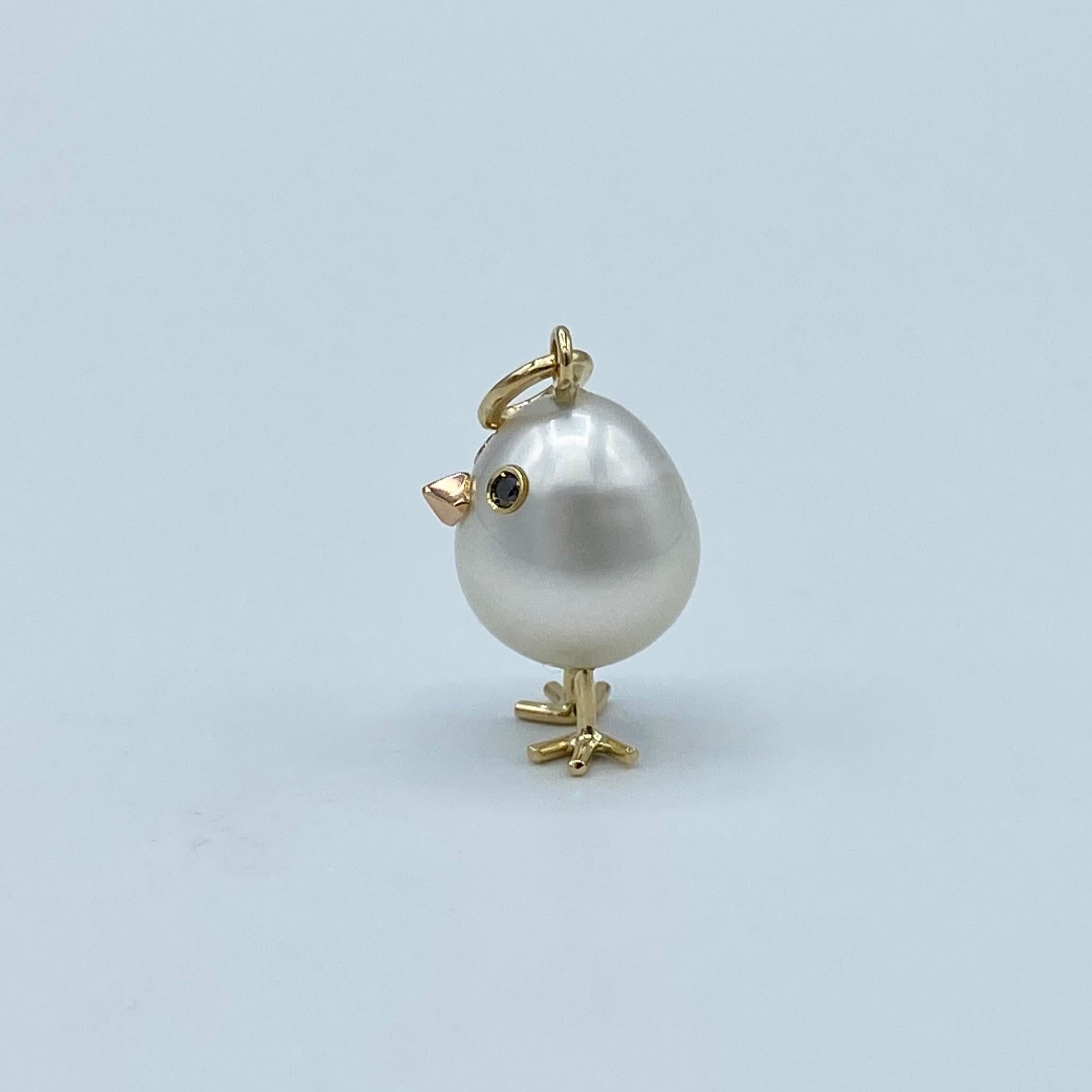 Chick Australian Pearl Diamond Yellow Red white 18 Kt Gold Pendant or Necklace
A oval shape Australian pearl has been carefully crafted to make a chick. He has his two legs, two eyes encrusted with two black diamonds and his beak. 
The gold is