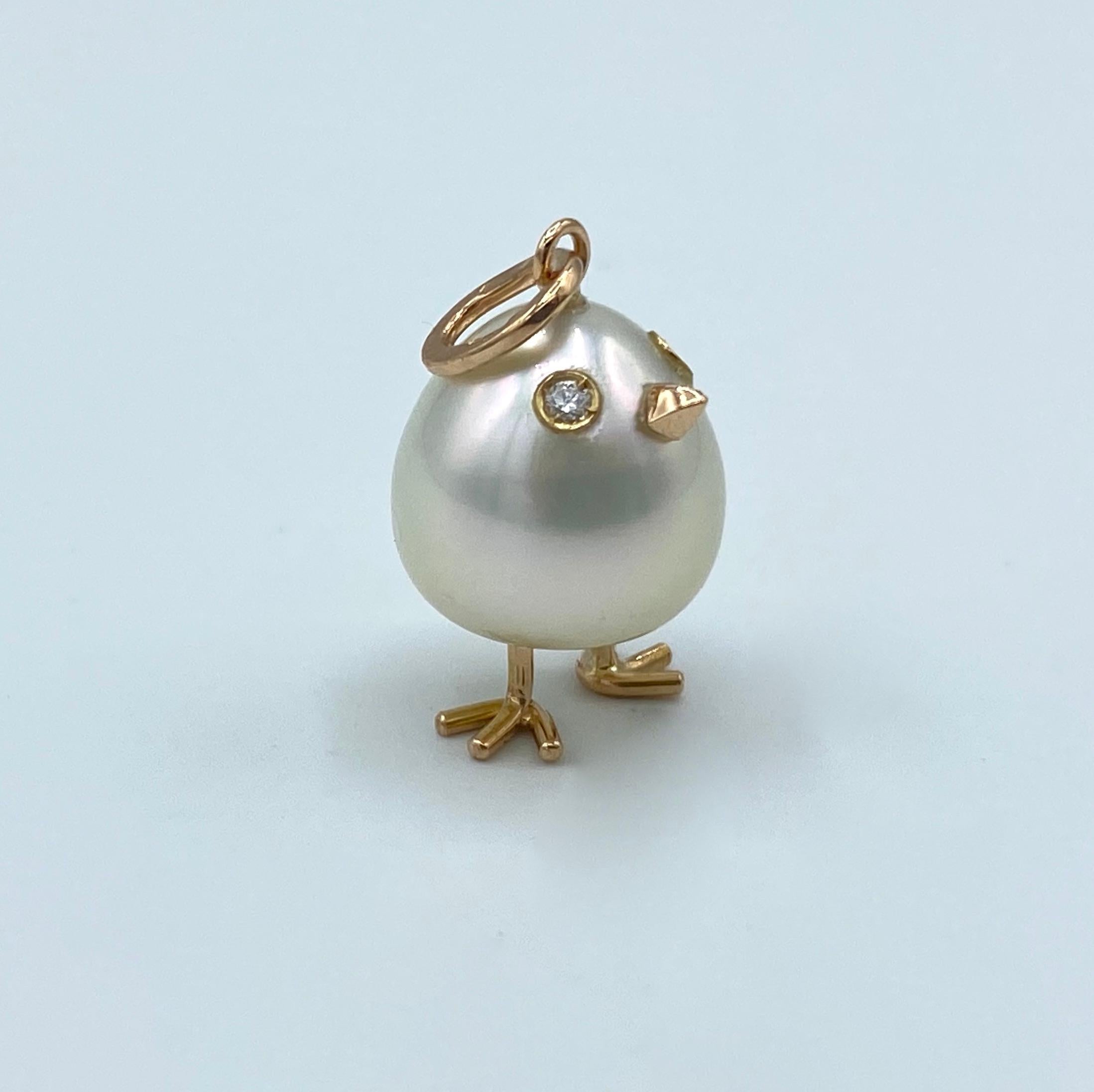 Chick Australian Pearl Diamond Yellow Red white 18 Kt Gold Pendant or Necklace
A oval shape Australian pearl has been carefully crafted to make a chick. He has his two legs, two eyes encrusted with two white diamonds and his beak. 
The gold is