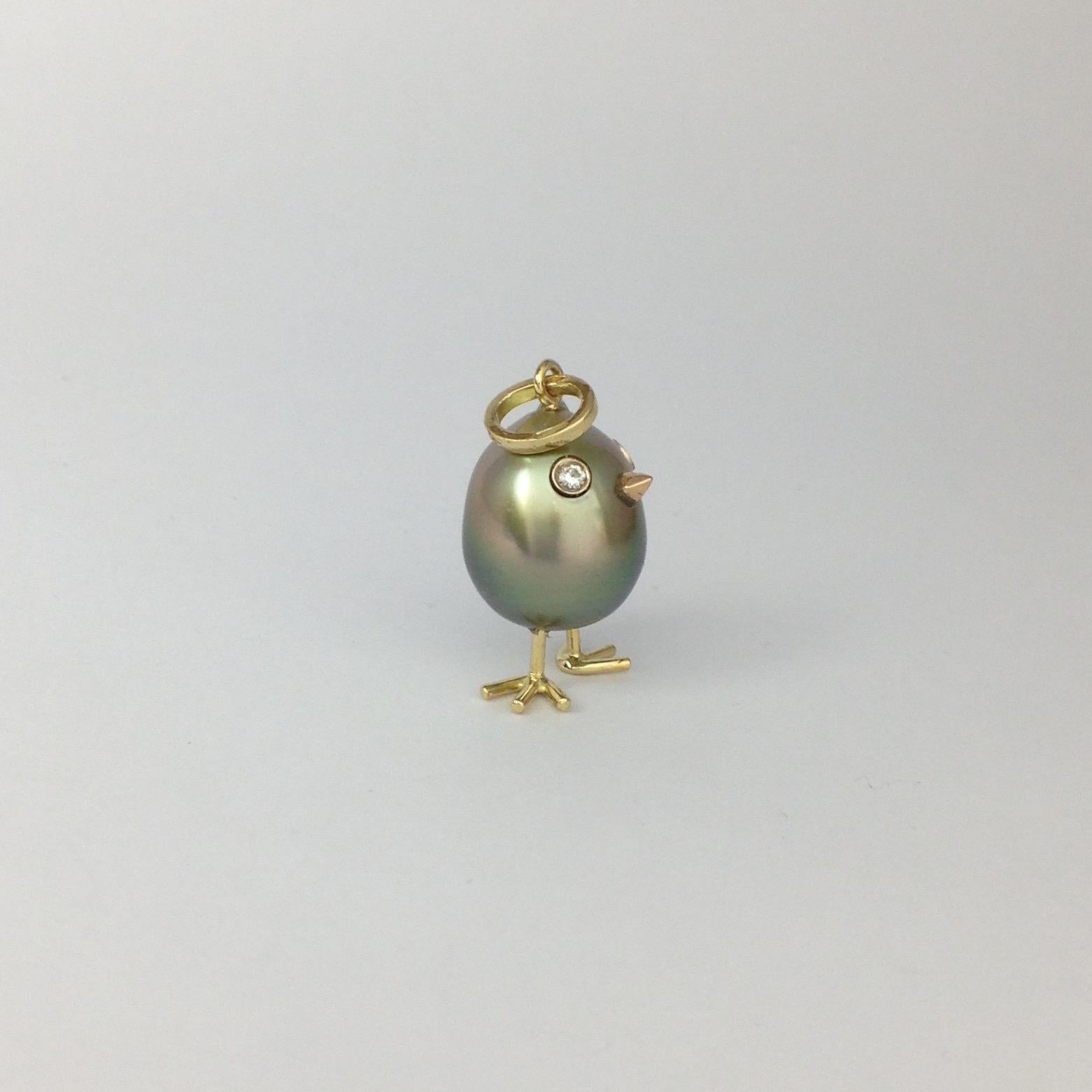 A beautiful Tahitian pearl has been carefully crafted to make a chick. He has his two legs, two eyes encrusted with two brown diamonds and his beak. 
The gold is white for the eyes, the beak is red and the other particulars are in yellow gold.
The