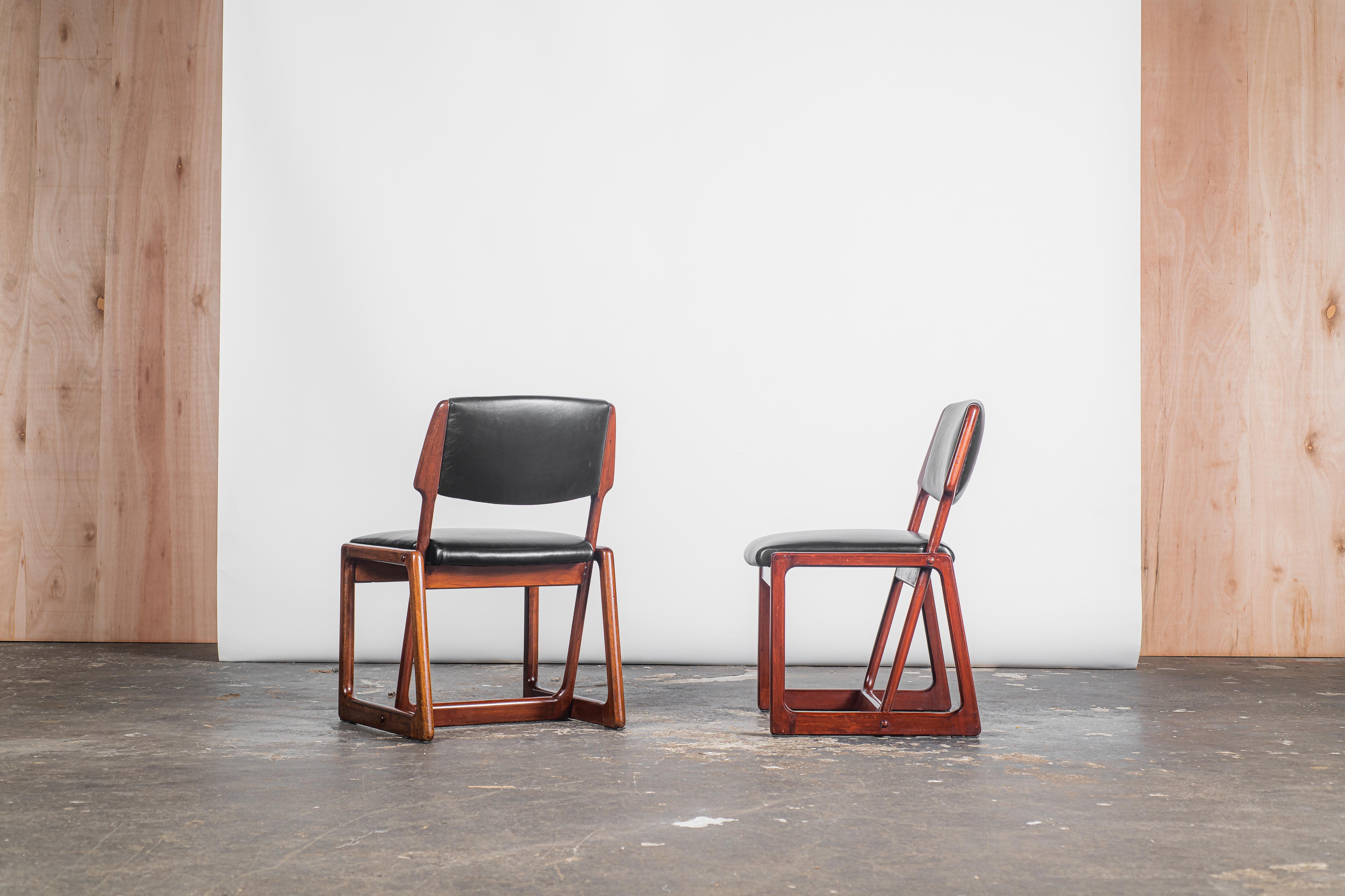 Allow me to introduce the mesmerizing Sergio Rodrigues -  Chico Chairs, a reduced and armless iteration of the renowned Cadeira Adolpho. Meticulously fashioned from solid wood, these chairs exude an air of sophistication, with their sleek seat and