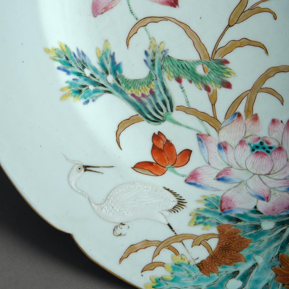 A fine Ch'ien-lung famille rose charger, decorated with lotus flowers, mandarin ducks, and a crane, circa 1780.