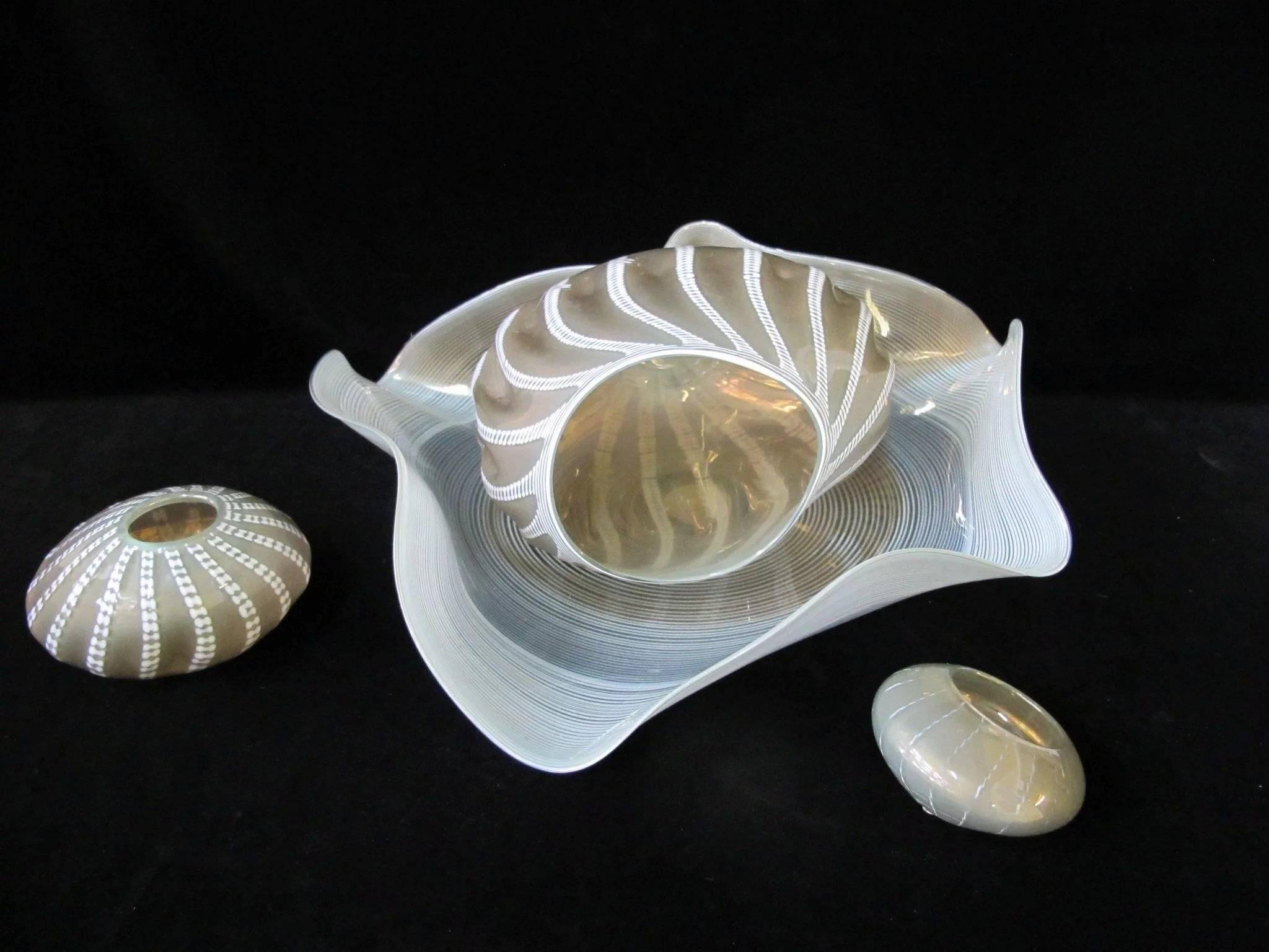 An authentic Dale Chihuly four-piece glass set Seaform sculpture in celadon and gray. It's signed at the base, no chips, cracks or repairs, and minimal surface scratching, mostly at the base.
Largest piece measures 27