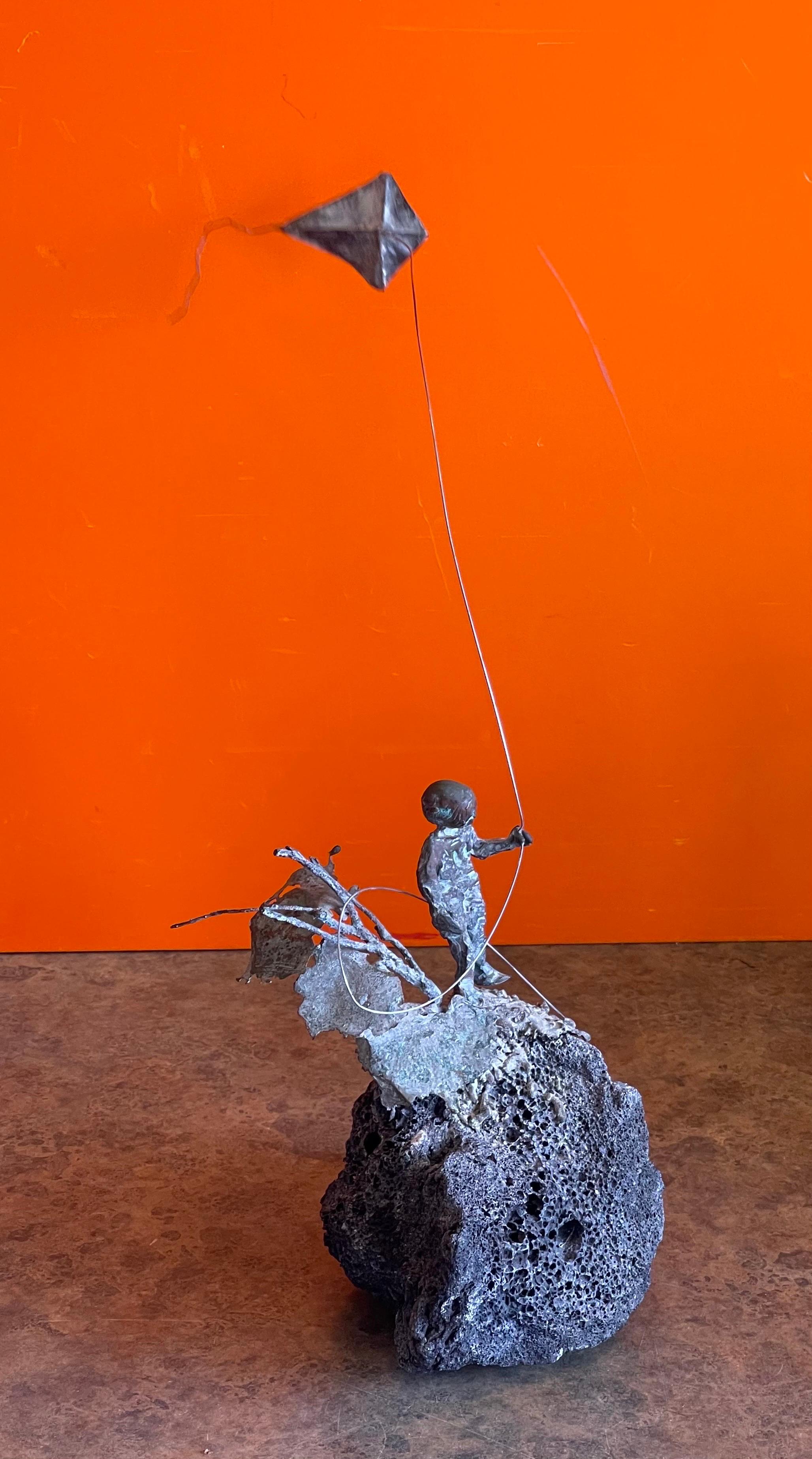 Child Flying Kite Bronze on Volcanic Rock Sculpture by Malcolm Moran 2