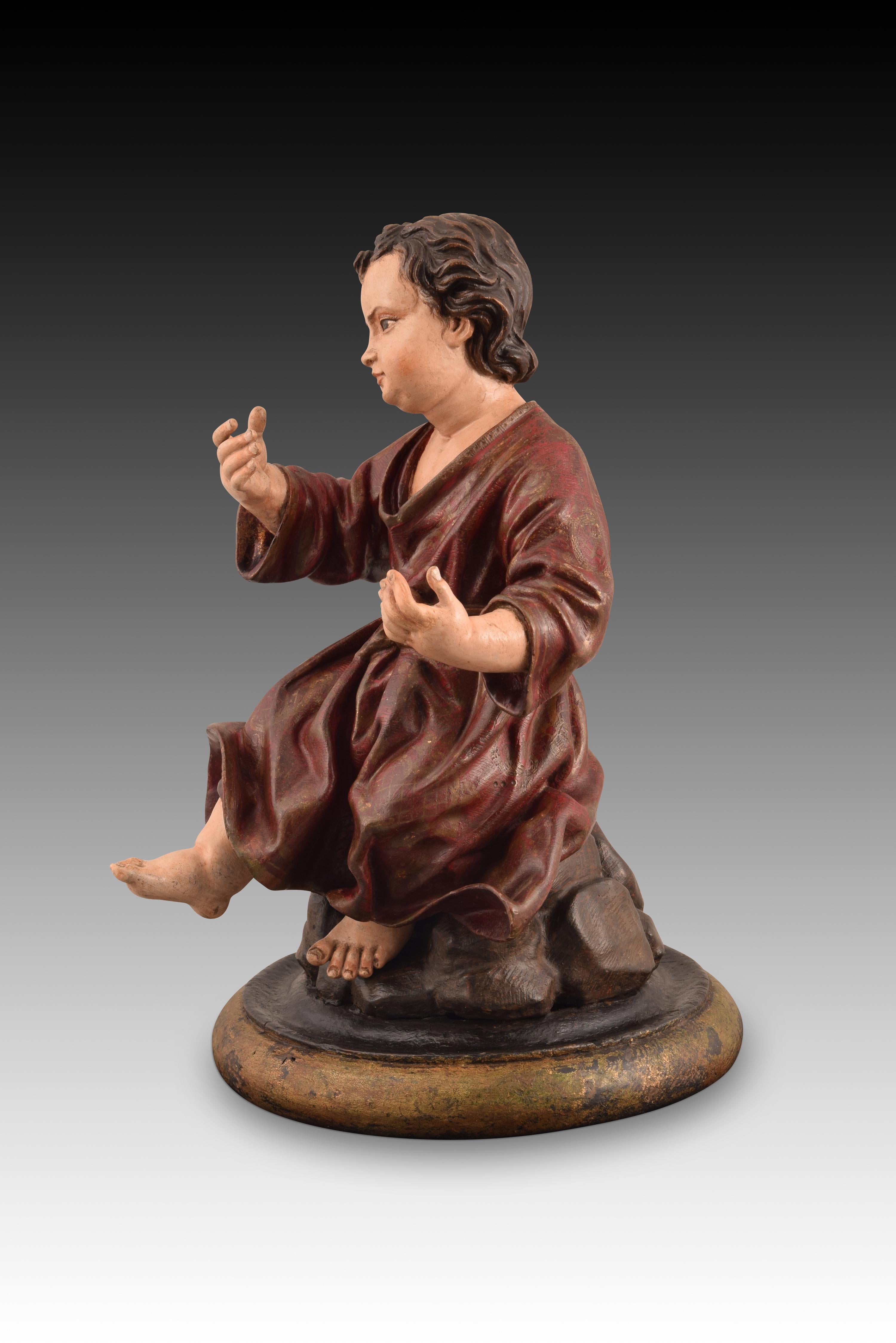Baby Jesus Passionist or Passionate. Carved and polychrome wood. Andalusian school, 18th century. 
Seated on a rocky promontory on a circular base, the polychrome wood carving of the Child Jesus is presented in a long-sleeved dress, tied with a belt
