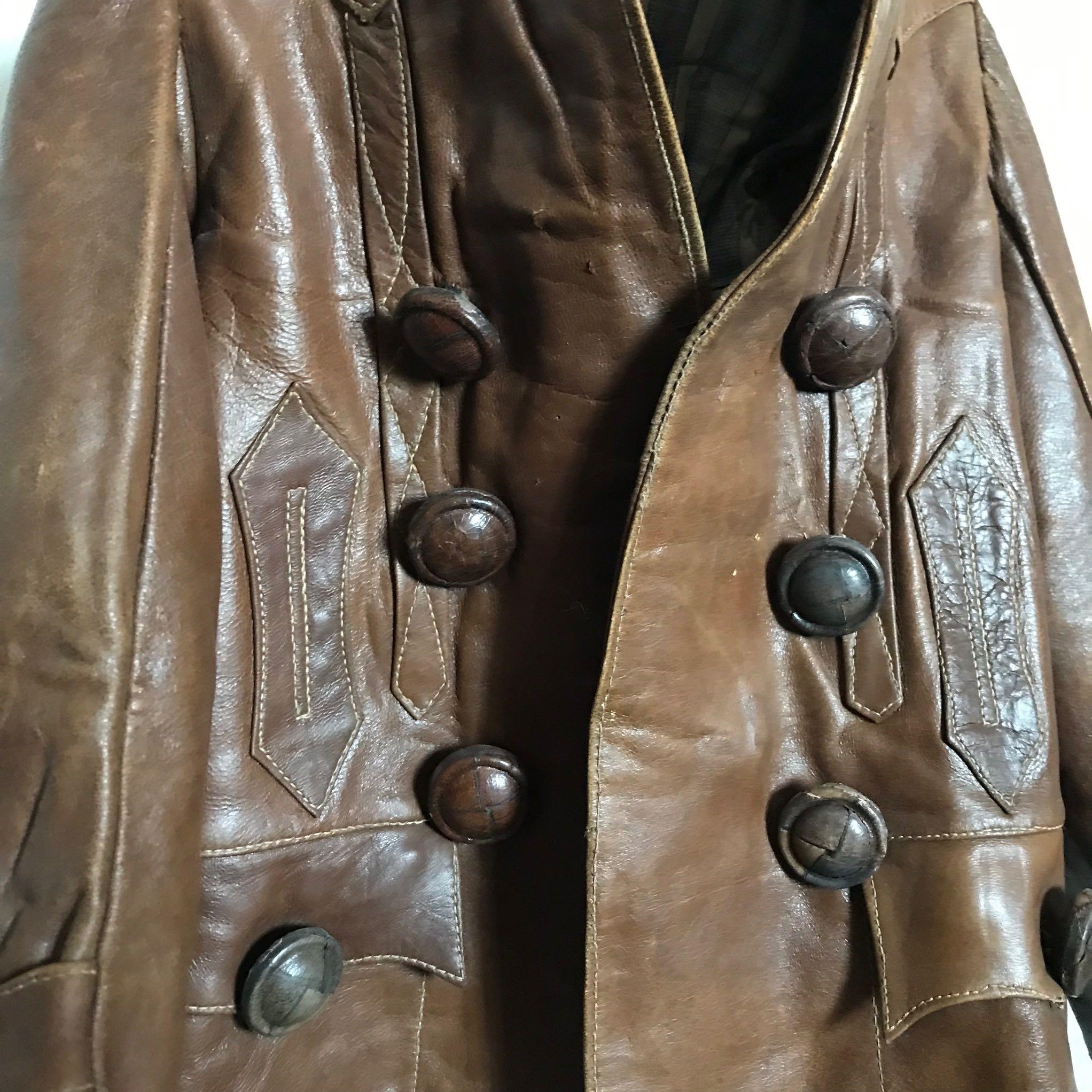 A child's leather jacket mounted on metal stand.