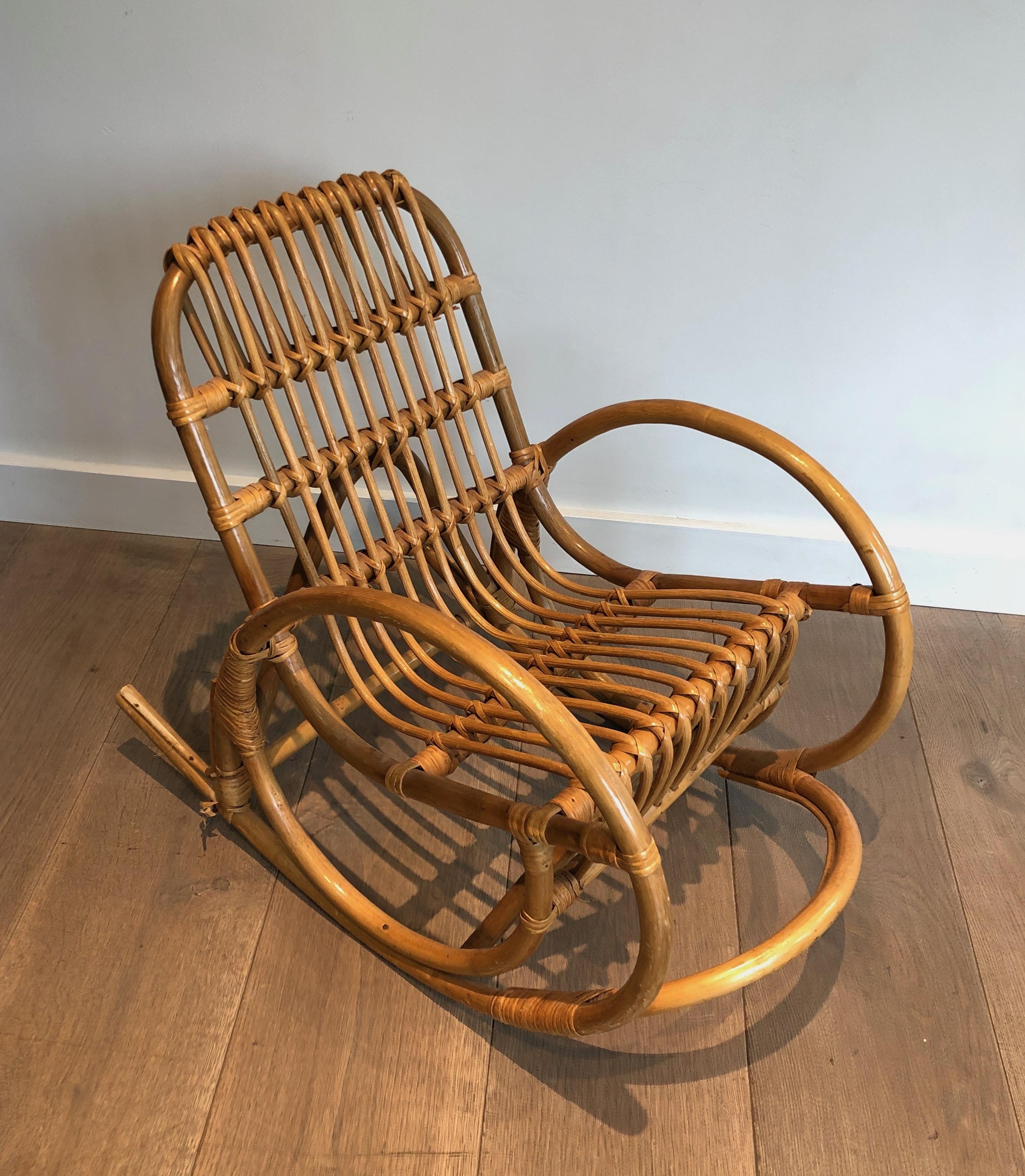 This very nice and unusual children rocking chair is made of rattan.  This is a French work. Circa 1970