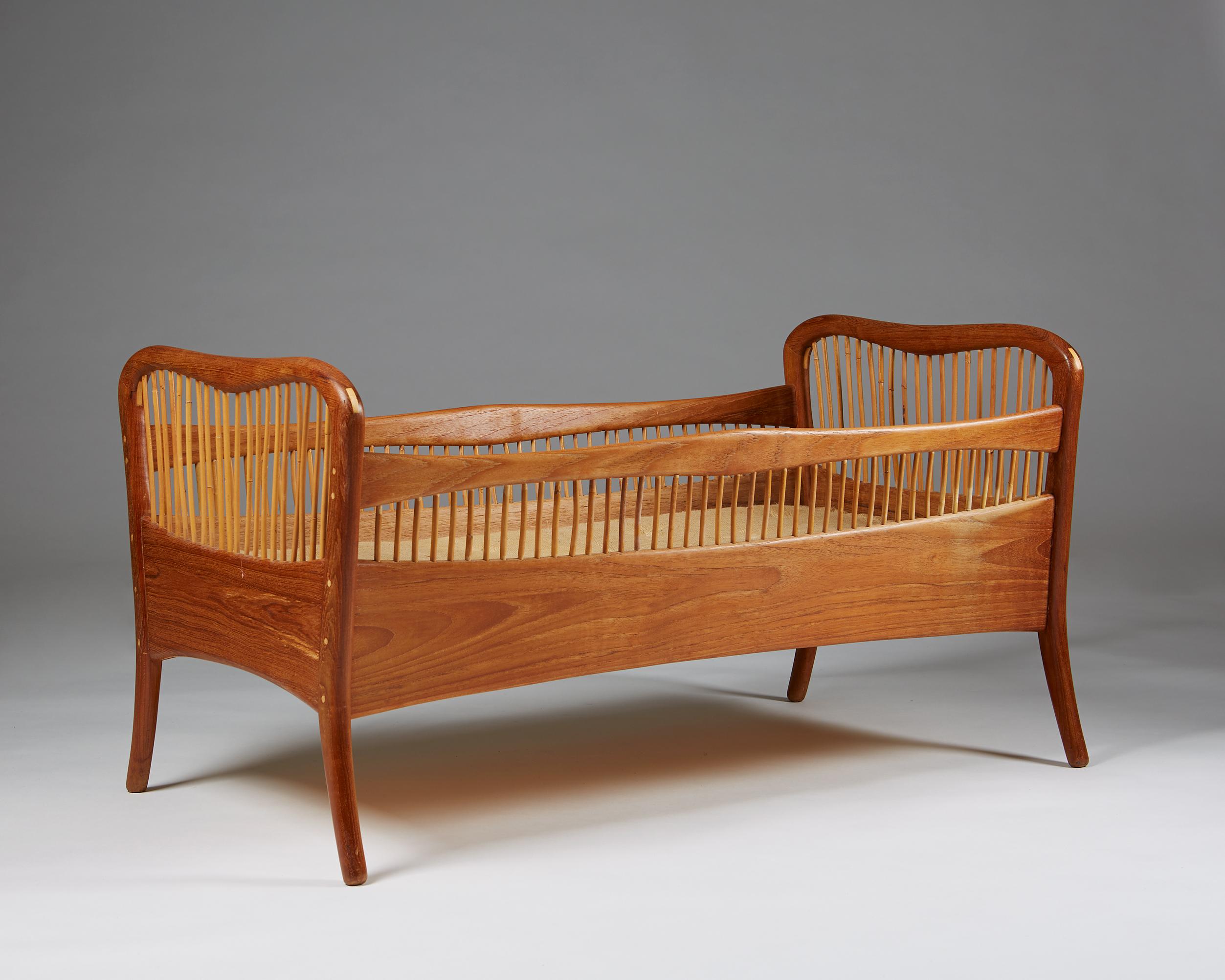 Childrens bed, anonymous, in the style of Peder Moos, made by cabinetmaker Ove Sørensen
Denmark. 1960-1961.

Teak with boxwood dowel pin joints, bamboo, and original mattress upholstered in hessian.

Dimensions:
L: 105 cm/ 3' 5 3/4''
W: 60 cm/ 23