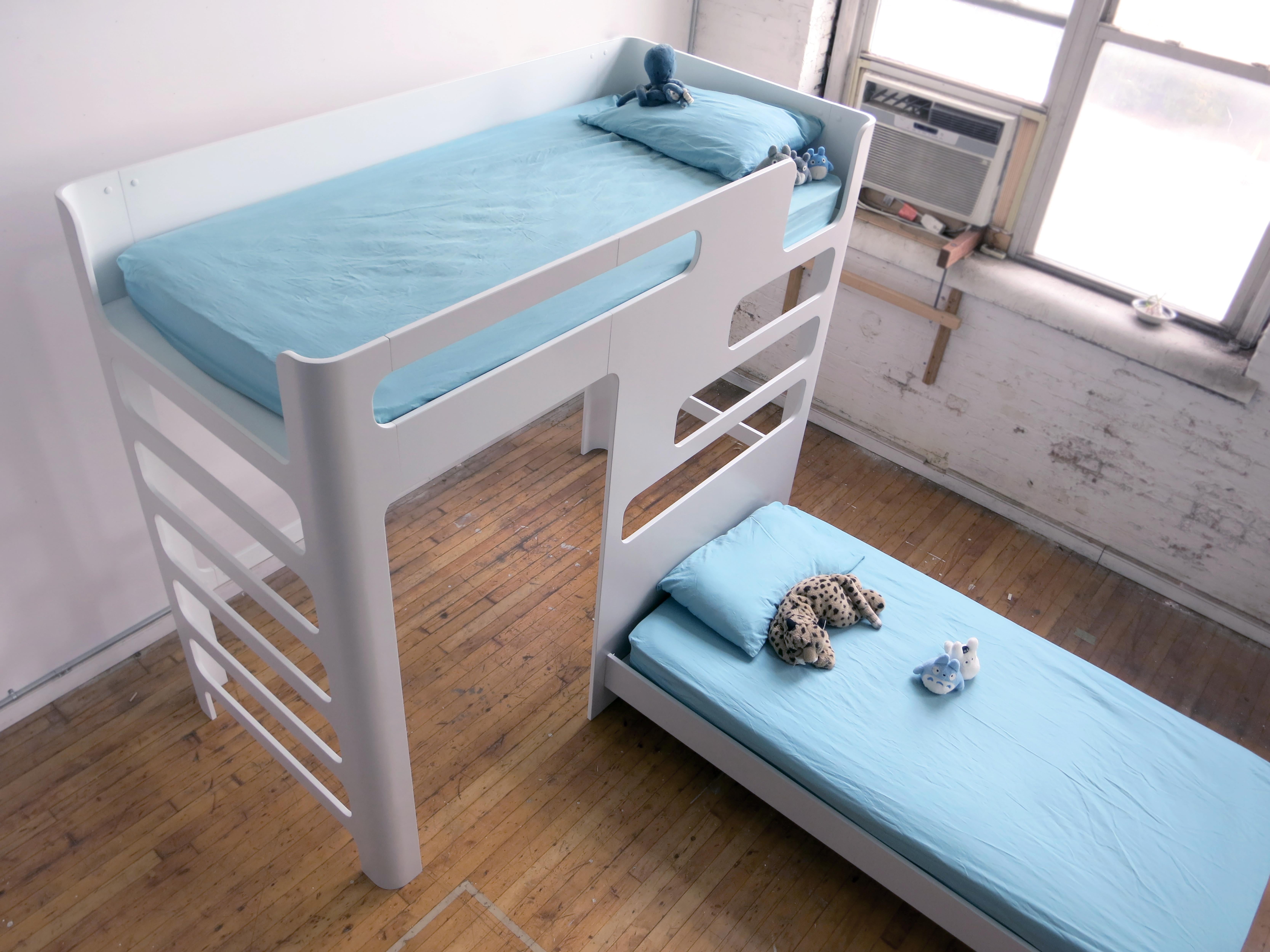 This is a kids' bunk bed. Ships flat and easily assembles with a simple cam and bolt fasteners. Pictured here are two full size mattresses. Main unit is lofted at 5 feet deck. Configuration, color, heights and mattress size can all be customized
