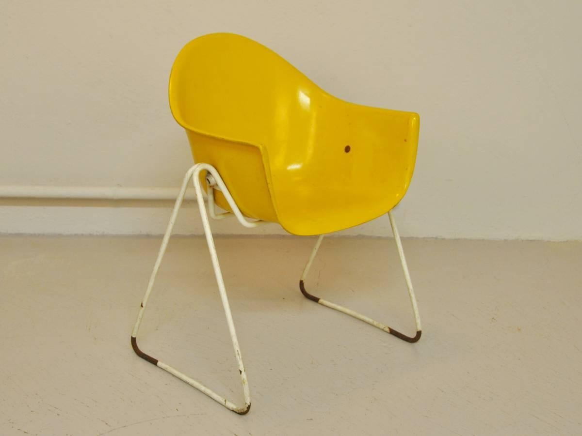 Rare fiberglass children's chair in yellow by Walter Papst for Wilkhahn. A design from the early 1960's. The chair is in a used condition. This shows on the steel frame and the shell. Some paint is missing and the shell does have a hairline crack.
