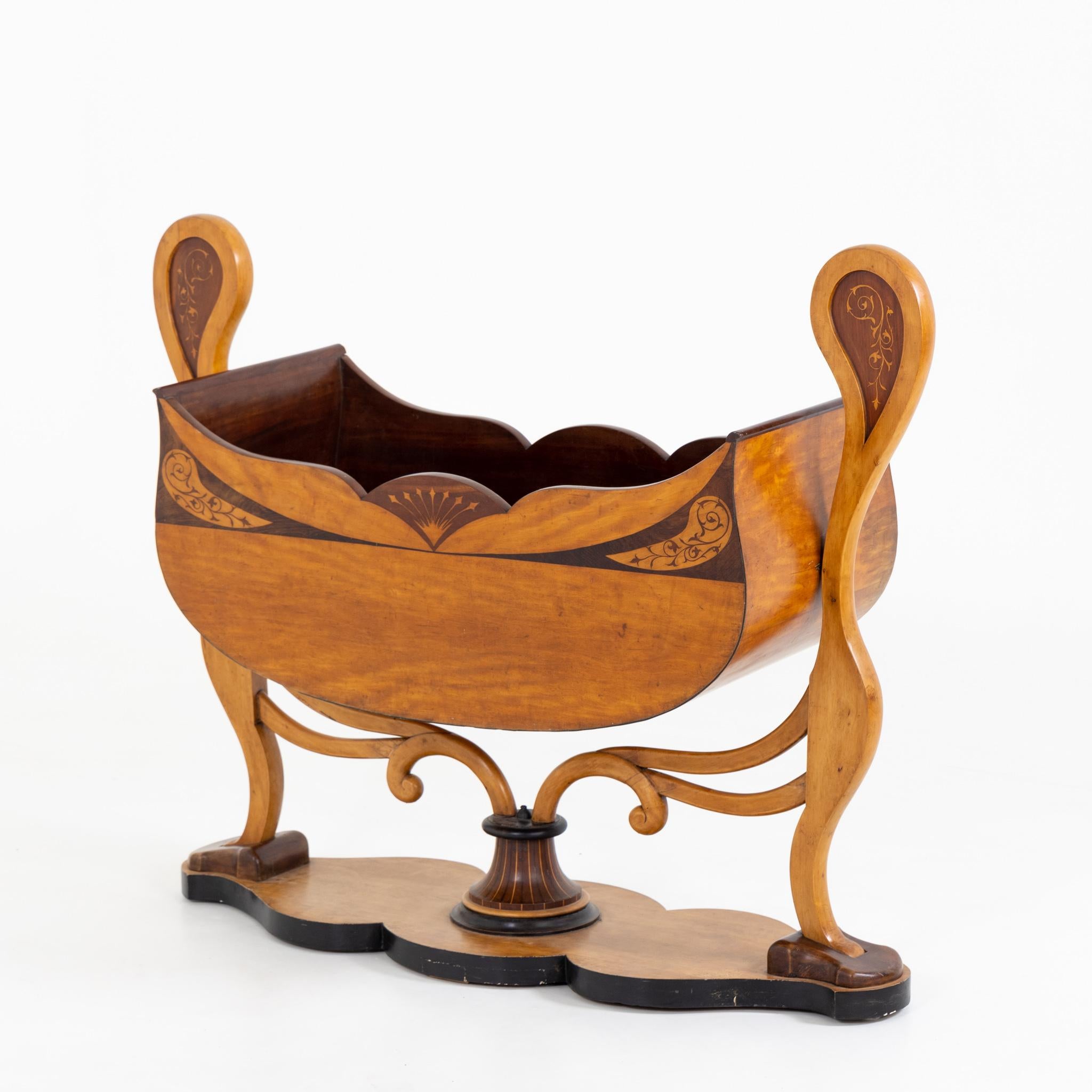 Cradle for children with elegantly curved frame and gondola-shaped bassinet. Very beautiful inlay work in the form of vines.