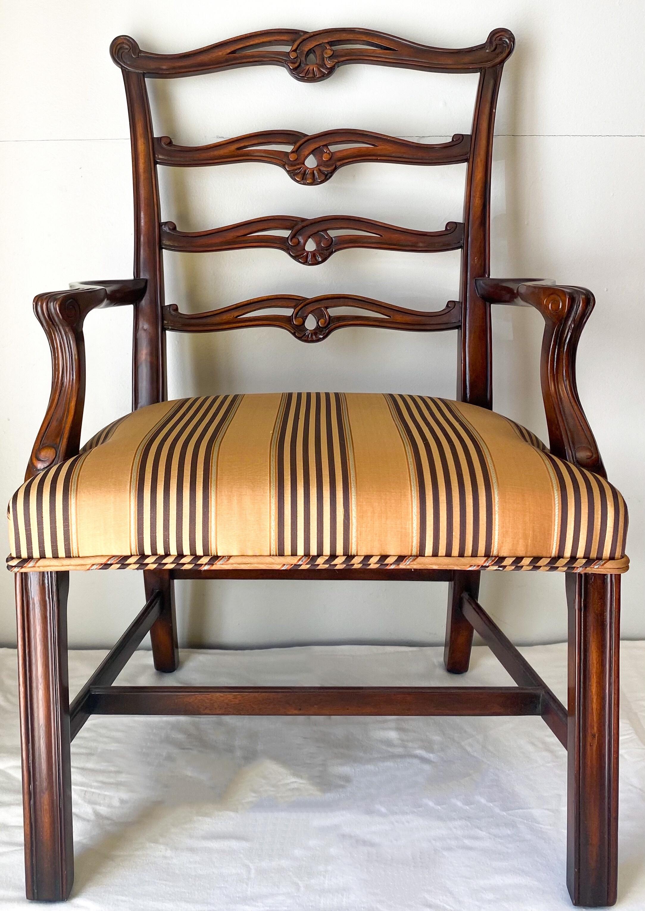 This is a pair of children’s mahogany chairs attributed to Theodore Alexander. The vintage stripe upholstery is in very good condition. They date to the later part of the 20th century.